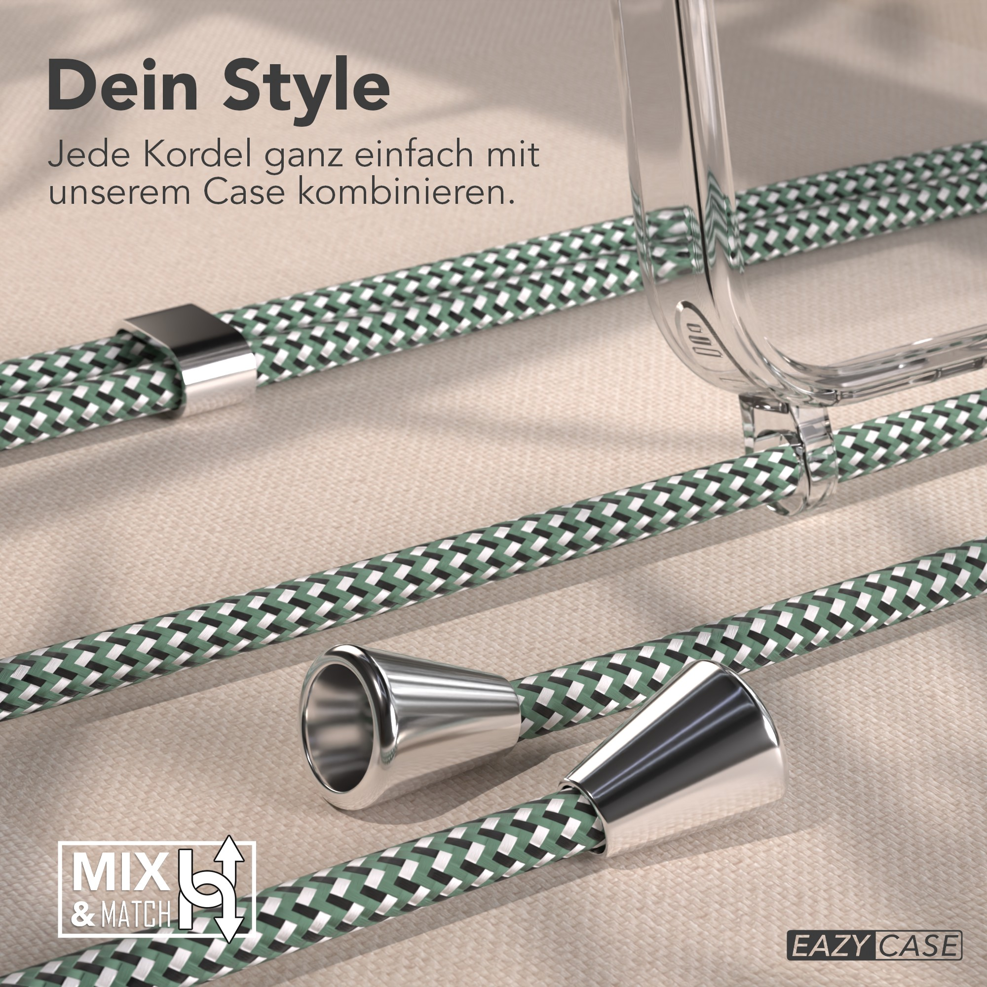 Das Bild zeigt grün-weiß gemusterte Kordeln, silberne Metalldetails und eine transparente Handyhülle auf beigem Hintergrund.