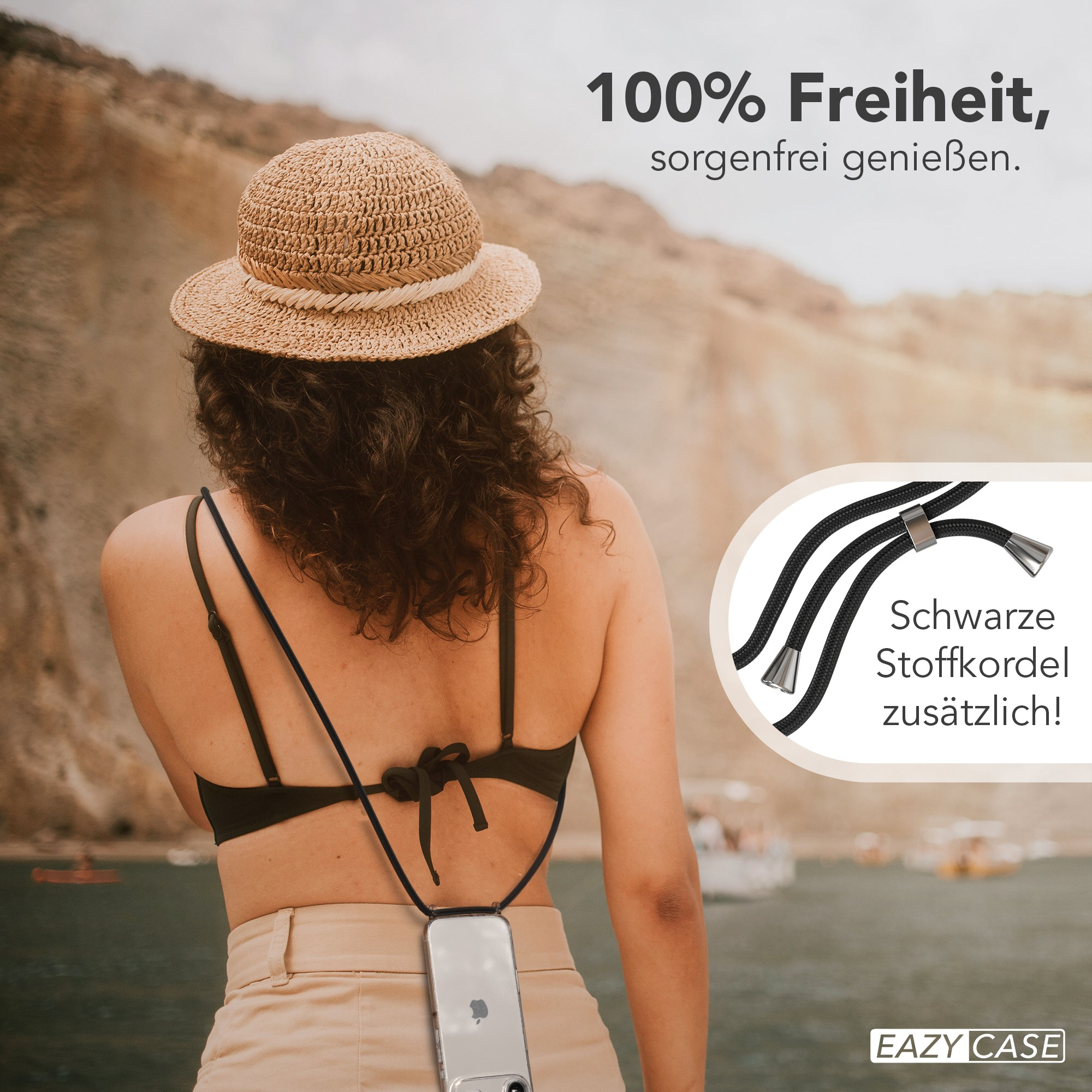 Frau mit Hut, schwarzem Oberteil und beiger Hose, die ein Telefon mit einem Umhängeband hält. Hintergrund See und Text.