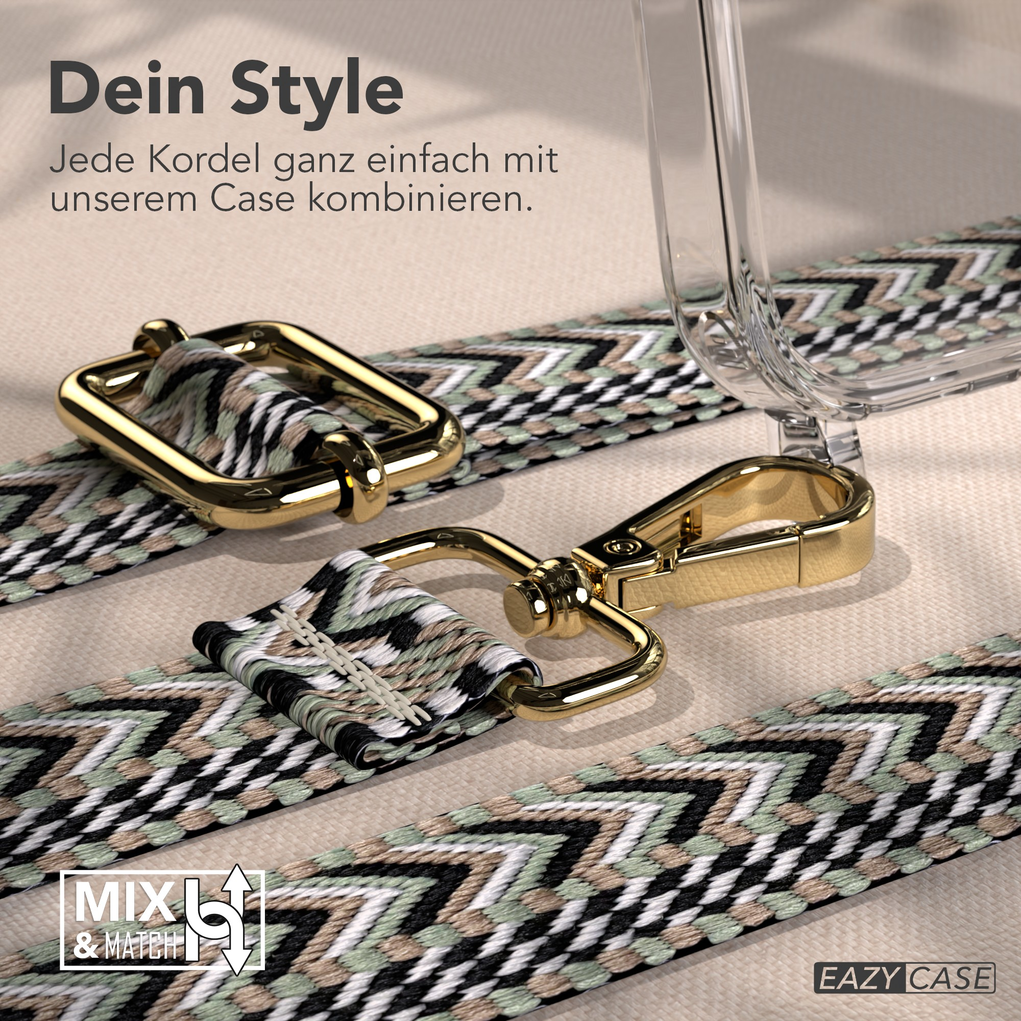 Ein Handyhüllenriemen mit goldenen Verschlüssen und einem gemusterten Riemen in Schwarz, Weiß und Grün, der auf einer beigen Oberfläche liegt.