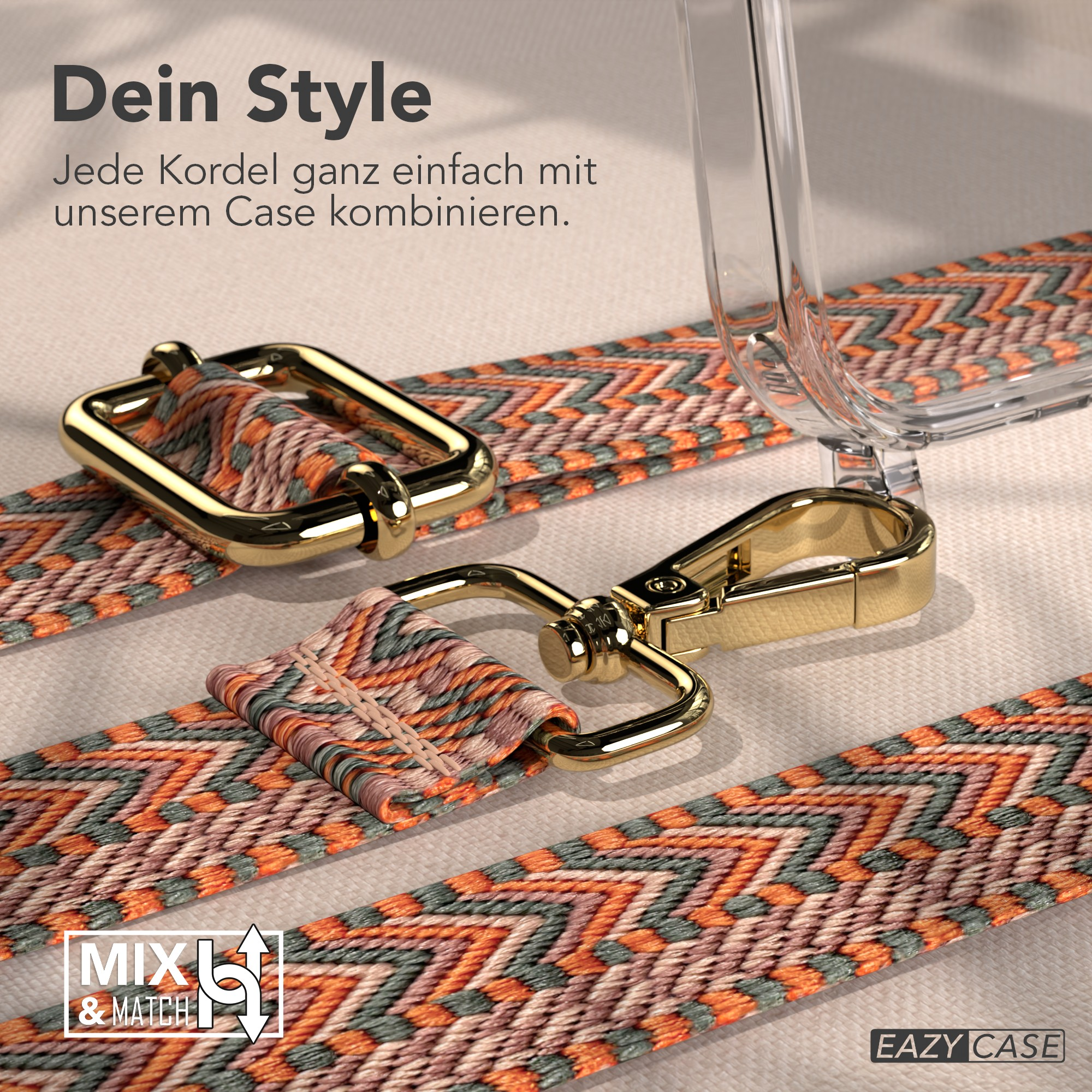 Nahaufnahme eines gemusterten Telefonriemens mit goldener Hardware. Der Riemen ist orange, grün und cremefarben. Eine klare Handyhülle ist sichtbar.