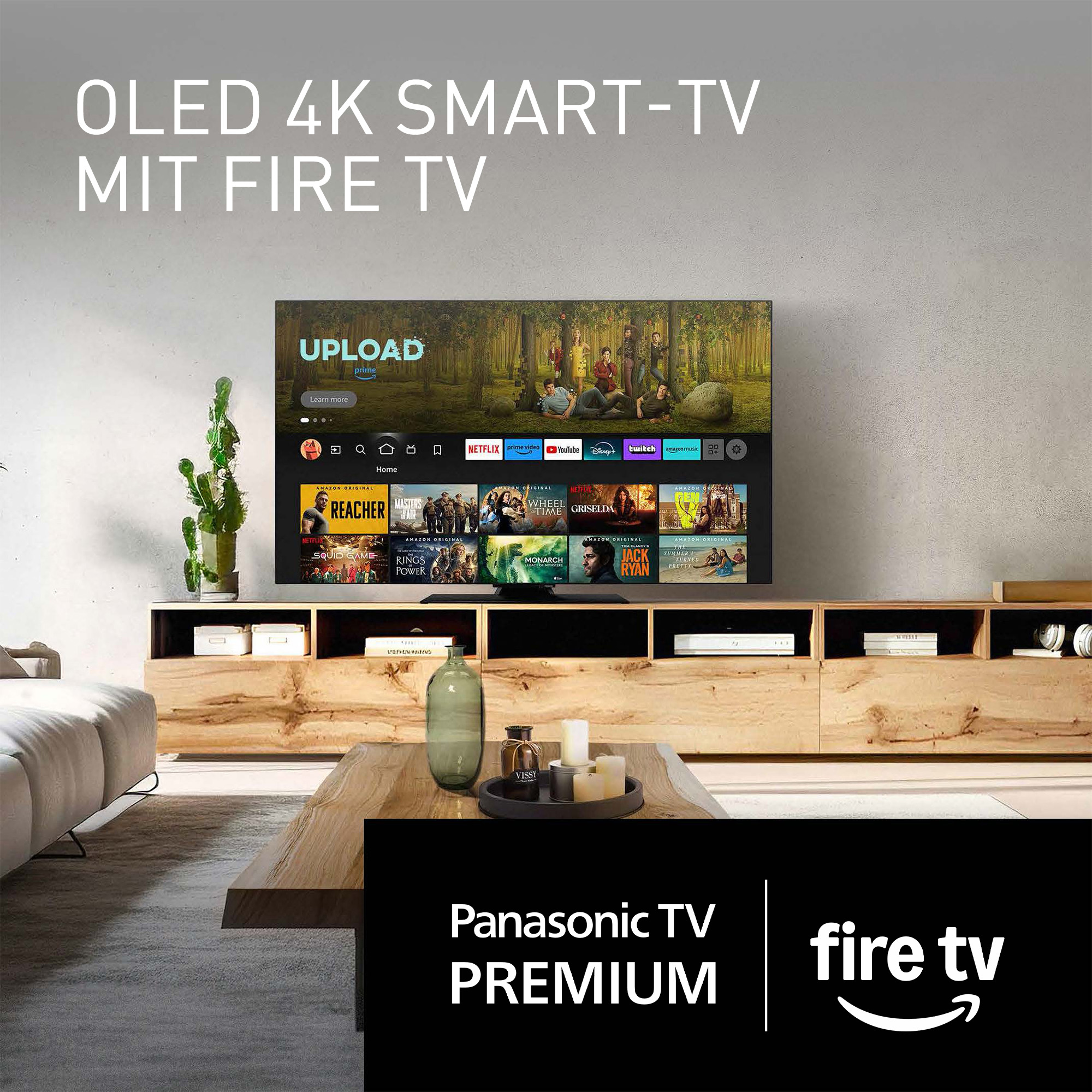 Una sala de estar moderna con un televisor grande que muestra contenido en streaming, una mesa de madera y un cactus.