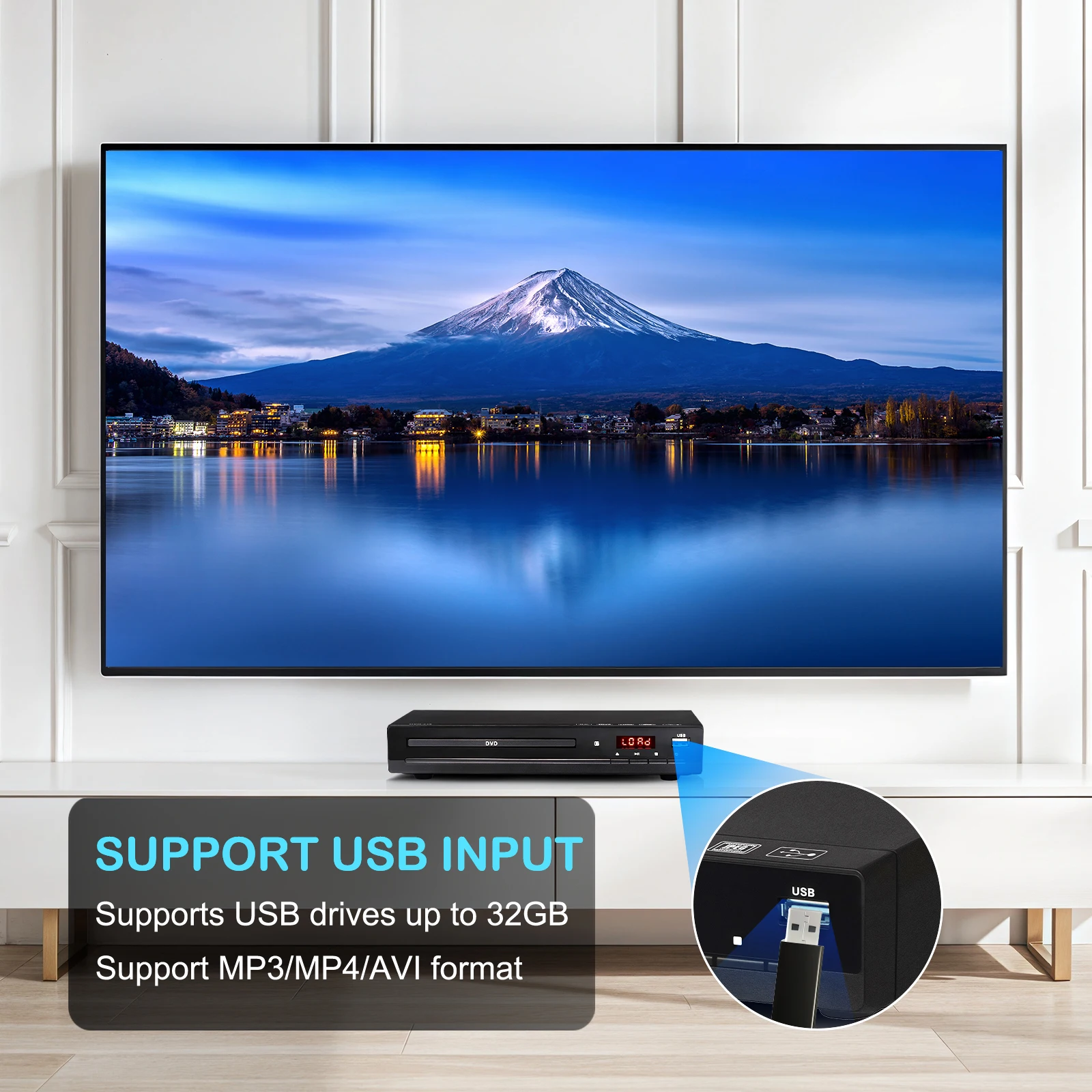 Ein Fernseher zeigt einen Berg über einem See. Darunter ein DVD-Player. Er unterstützt USB-Laufwerke und MP3/MP4/AVI-Formate.
