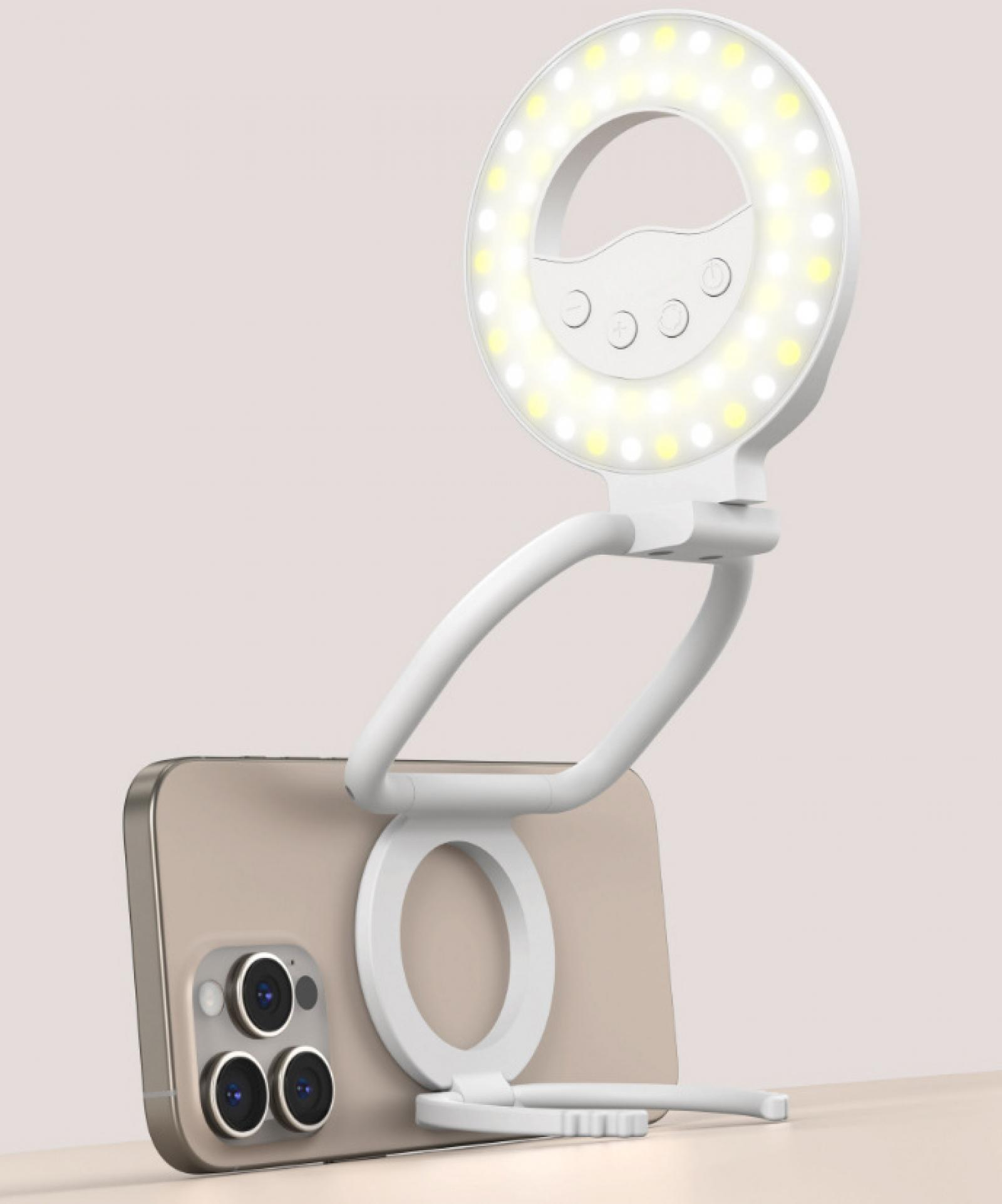 Ein weißes Ringlicht mit einem Telefon. Das Telefon ist golden. Der Hintergrund ist rosa.