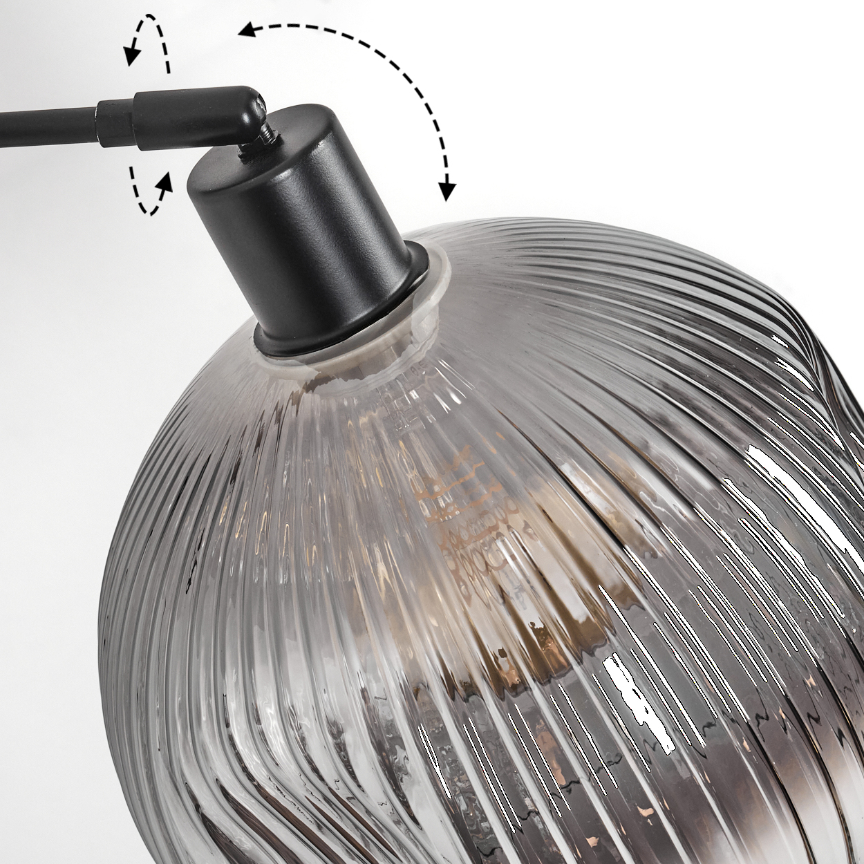 Nahaufnahme einer Glaslampe mit schwarzem Metallarm, geriffeltem Glasschirm und sichtbarer Glühbirne. Pfeile zeigen die Verstellbarkeit der Lampe an.