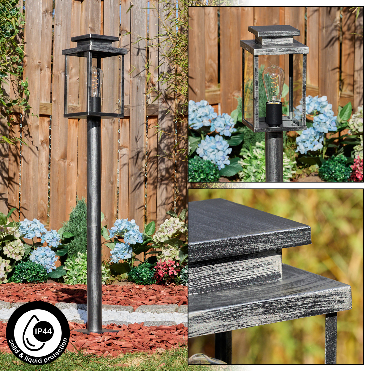 Eine Metall-Außenlampe in einem Garten mit hölzernem Zaun im Hintergrund. Blaue und rosa Blumen umgeben die Lampe. IP44-Symbol vorhanden.