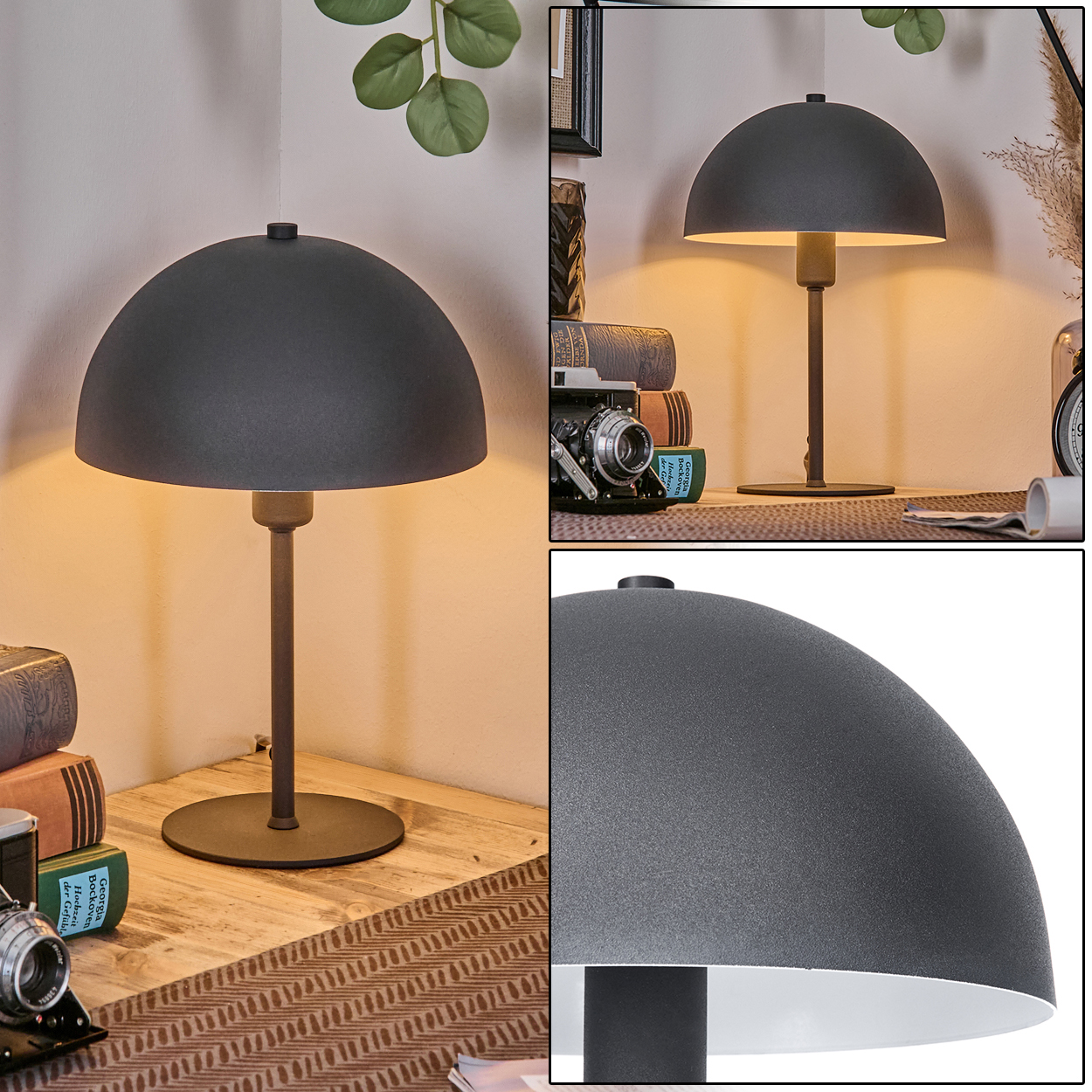 Eine graue Schreibtischlampe mit rundem Schirm steht auf einem Holztisch. Im Hintergrund sind Bücher und eine Kamera zu sehen.