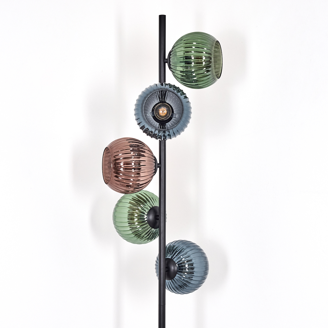 Moderne Lampe mit farbigen Glaskugeln. Grüne, blaue und braune Kugeln sind an einer schwarzen Metallstange befestigt.