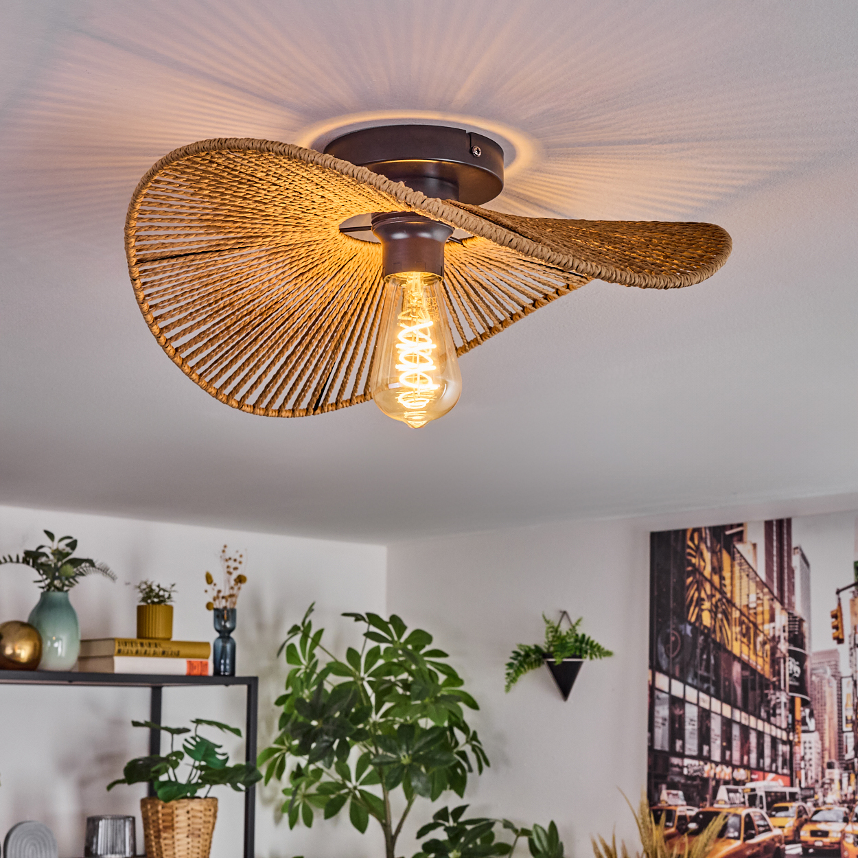 Eine dekorative Deckenlampe mit gewebtem Schirm, Glühbirne und modernem Innenraum mit Pflanzen und Kunstwerken.