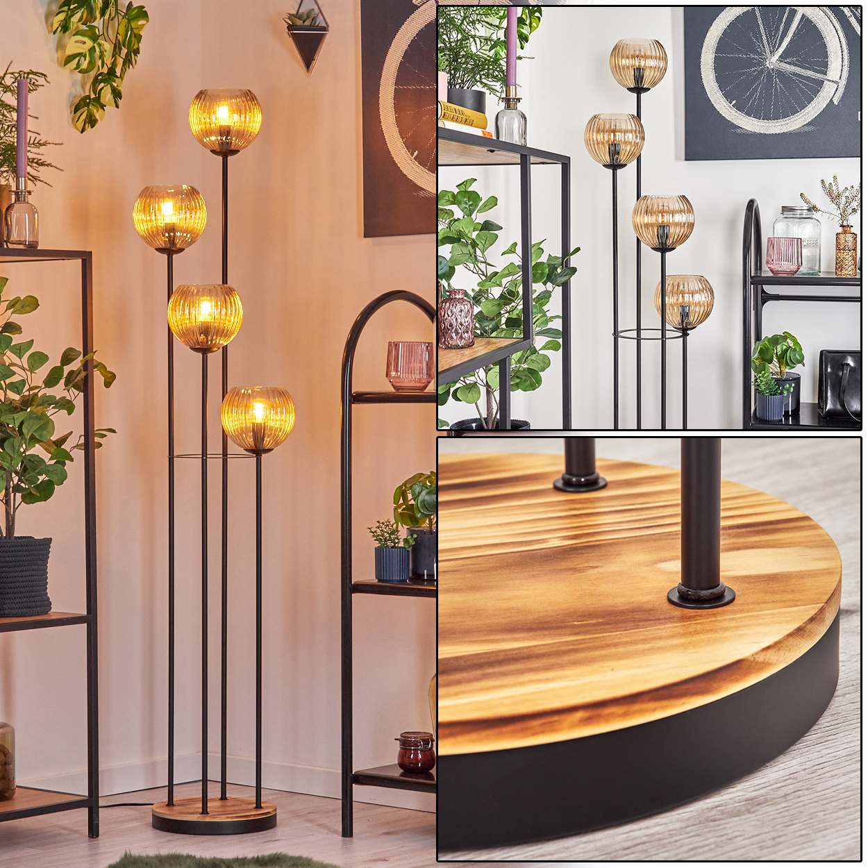 Eine Stehlampe mit vier bernsteinfarbenen Glaskugeln, schwarzem Metallrahmen und Holzsockel. Regale mit Pflanzen und Dekoration im Hintergrund.