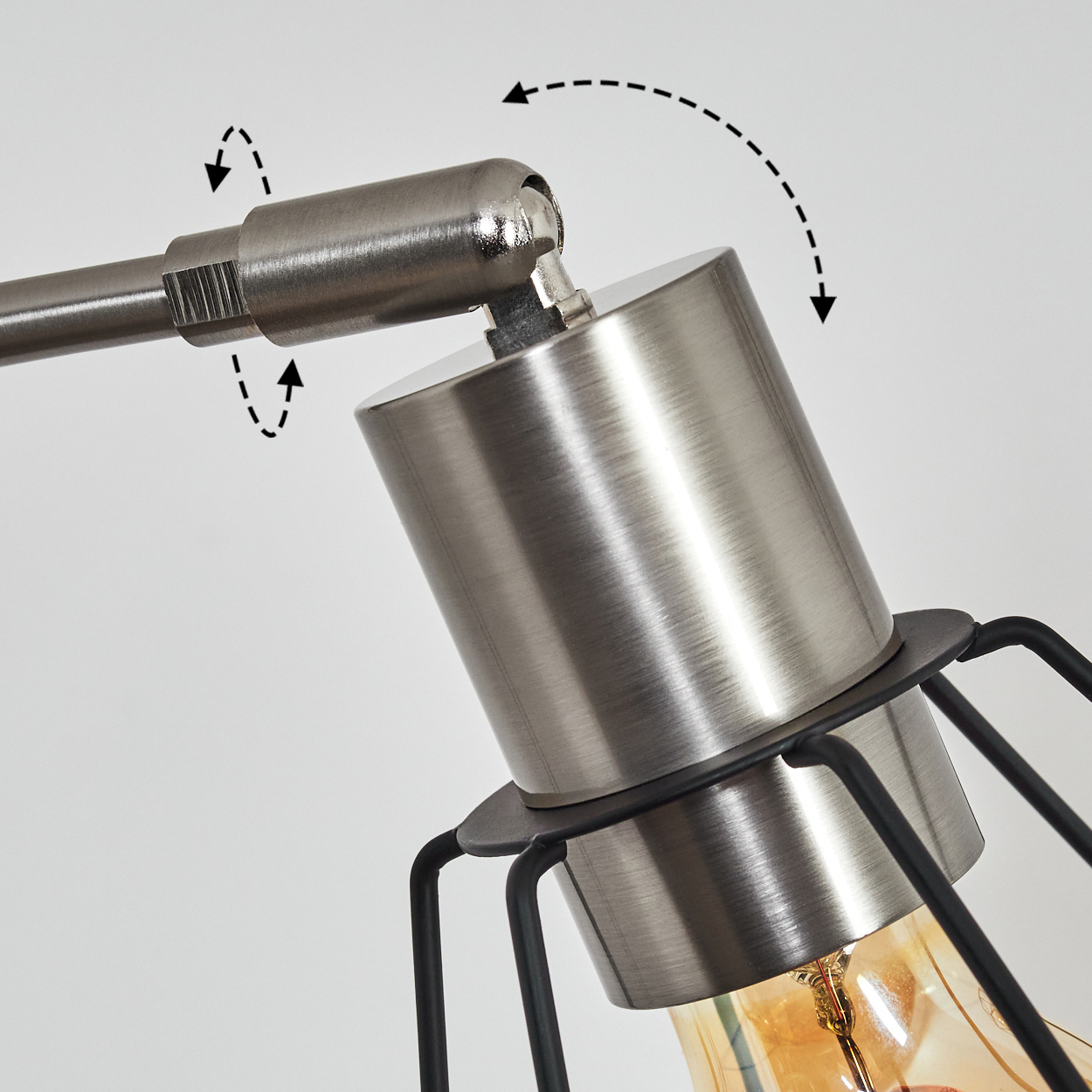 Nahaufnahme einer Lampe mit verstellbarem Arm. Metallisches Finish, schwarzer Käfig und warme Glühbirne. Pfeile zeigen die Bewegung des Arms.