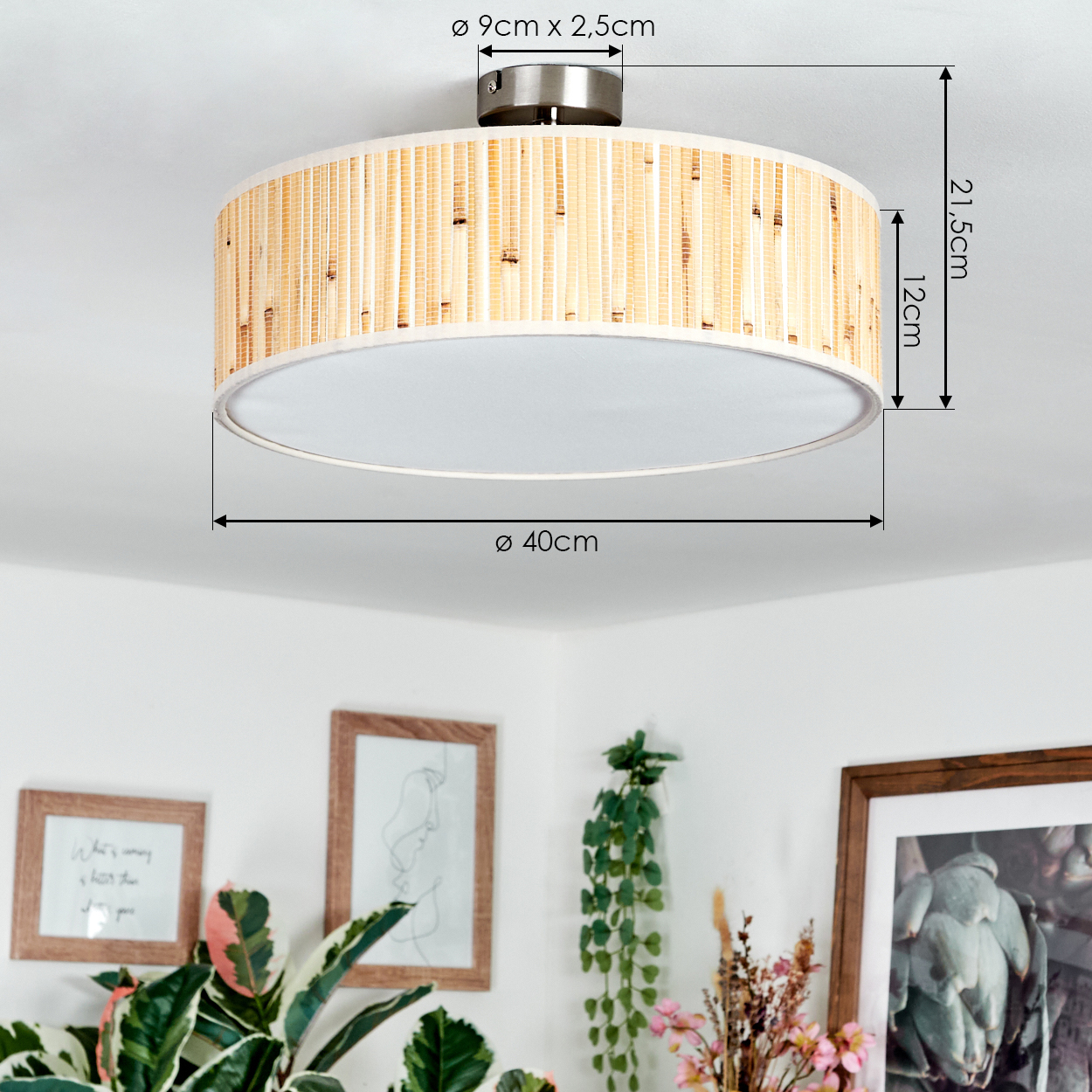 Eine Deckenlampe aus Bambus wird gezeigt. Maße sind angegeben. Im Hintergrund sind gerahmte Bilder und Pflanzen. Die Wand ist weiß.