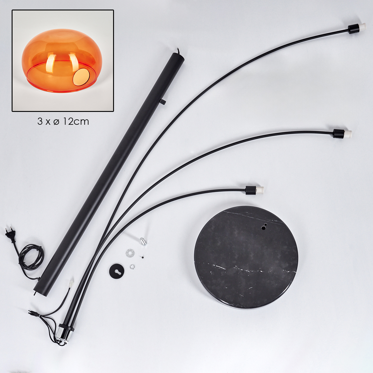 Zerlegte moderne Lampe. Teile umfassen schwarze gebogene Arme, einen runden Marmorsockel, einen orangefarbenen Glasschirm und verschiedene Schrauben.