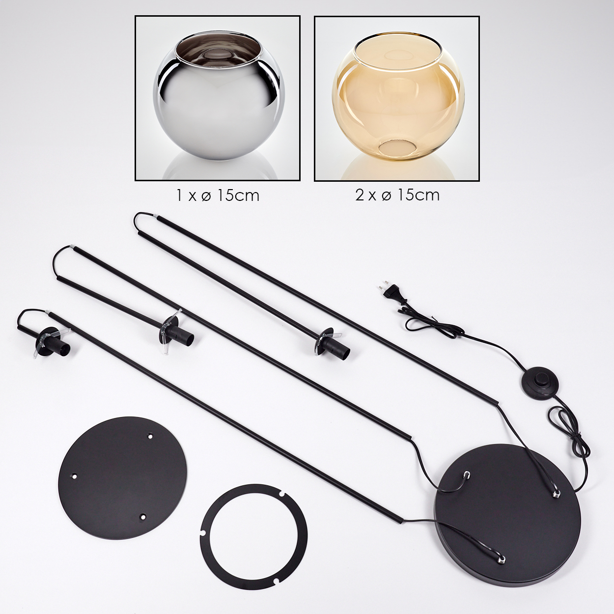 Das Bild zeigt zerlegte Lampenteile: zwei Glasschalen, schwarze Metallstangen, eine kreisförmige Basis und ein Netzkabel.