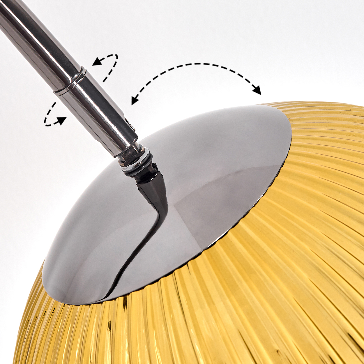 Nahaufnahme einer Lampe. Ein Chromarm verbindet sich mit einem reflektierenden silbernen Schirm über einem gelben, gerippten Glasschirm. Pfeile zeigen die Bewegung an.