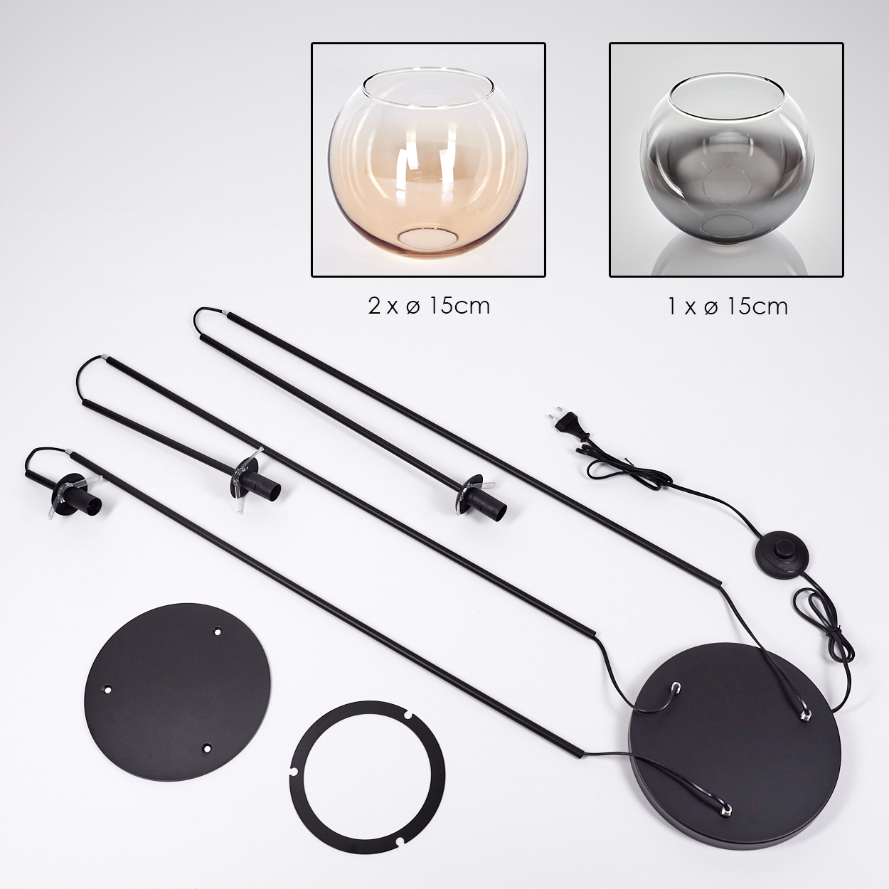 Das Bild zeigt zerlegte Teile einer Lampe. Es enthält Glasschalen, schwarze Metallstäbe, Sockel und ein Netzkabel.