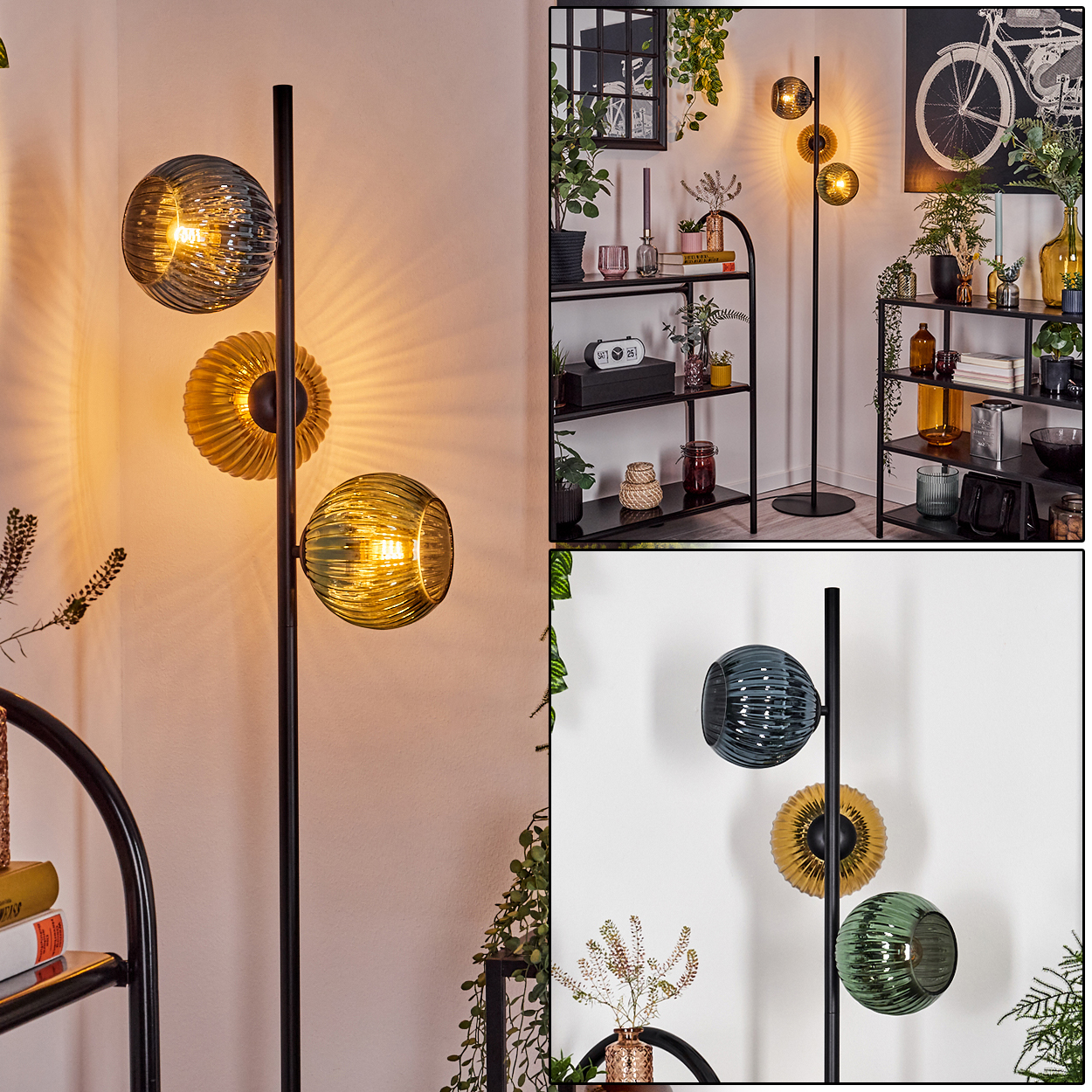 Eine moderne Stehlampe mit drei Glaskugeln in Blau, Gold und Grün. Vor einer weißen Wand mit schwarzen Regalen und Dekoration.