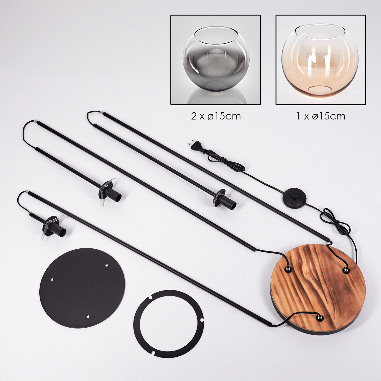 Zerlegte Lampe mit Glasschalen, Metallstangen, Holzsockel und schwarzen Kreisteilen auf weißer Oberfläche.