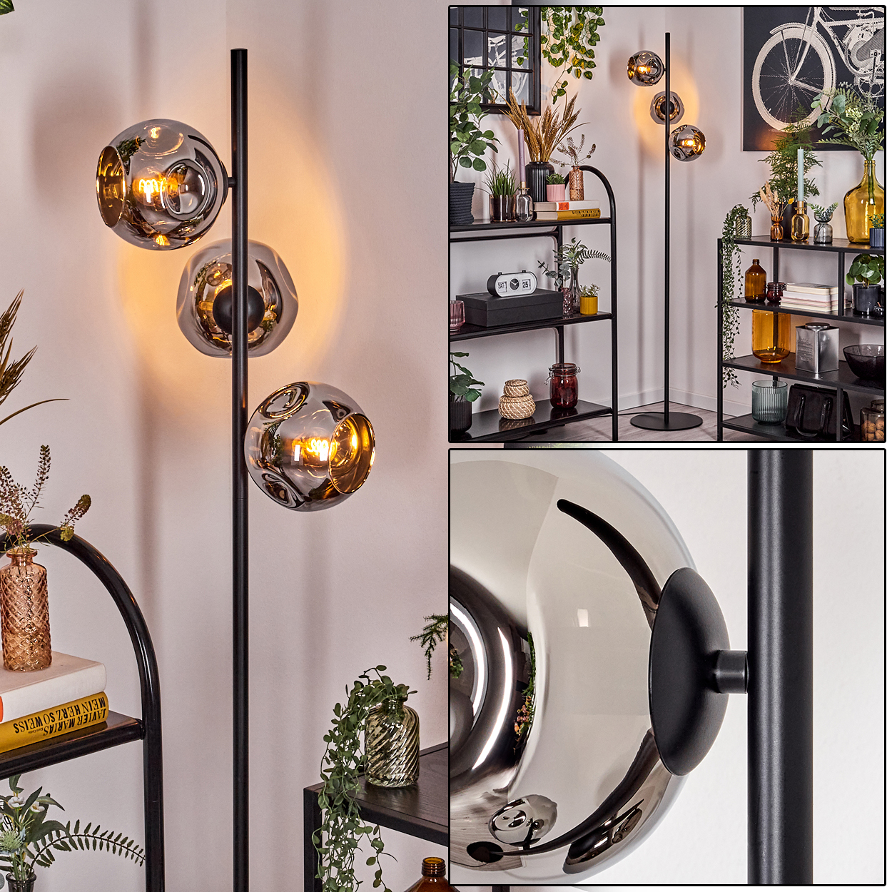 Eine moderne Stehlampe mit drei kugelförmigen Schirmen. Die Lampe ist schwarz mit einem silbergrauen Farbton. Im Hintergrund Regale mit Dekorationen.