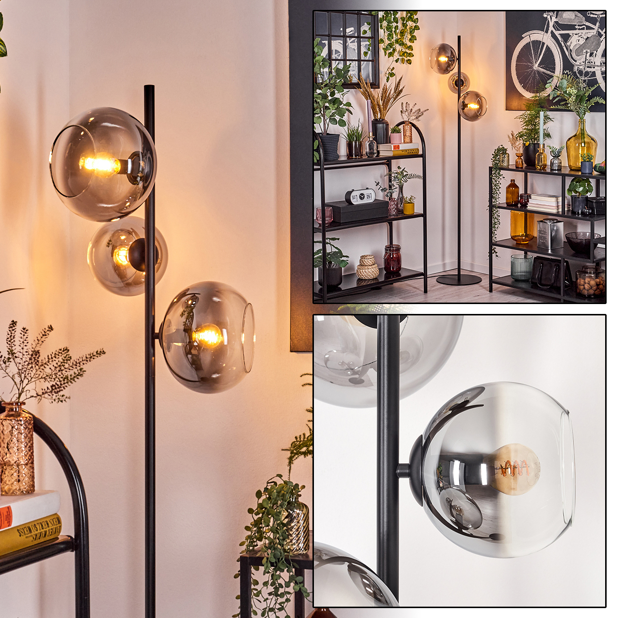 Eine moderne Stehlampe mit drei kugelförmigen Schirmen. Die Lampe ist schwarz, die Schirme sind grau. Der Hintergrund umfasst Regale mit Pflanzen und Dekor.