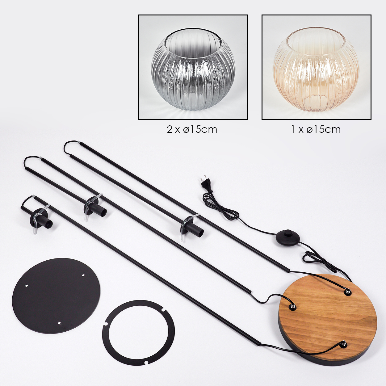 Ein zerlegtes Lampen-Kit mit Glasschirmen und schwarzen Metallkomponenten auf weißer Oberfläche. Holzsockel und Netzkabel enthalten.