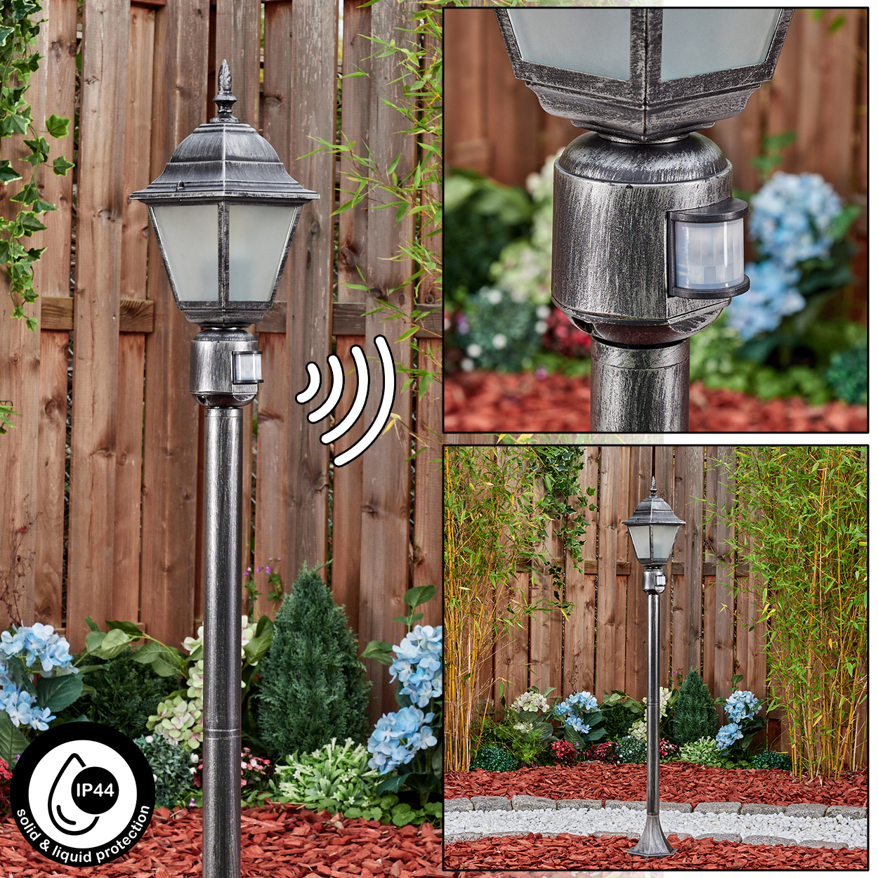 Eine silberne Außenlampe mit Bewegungssensor. Sie steht in einem Garten mit Holzzaun, Blumen und Pflanzen.