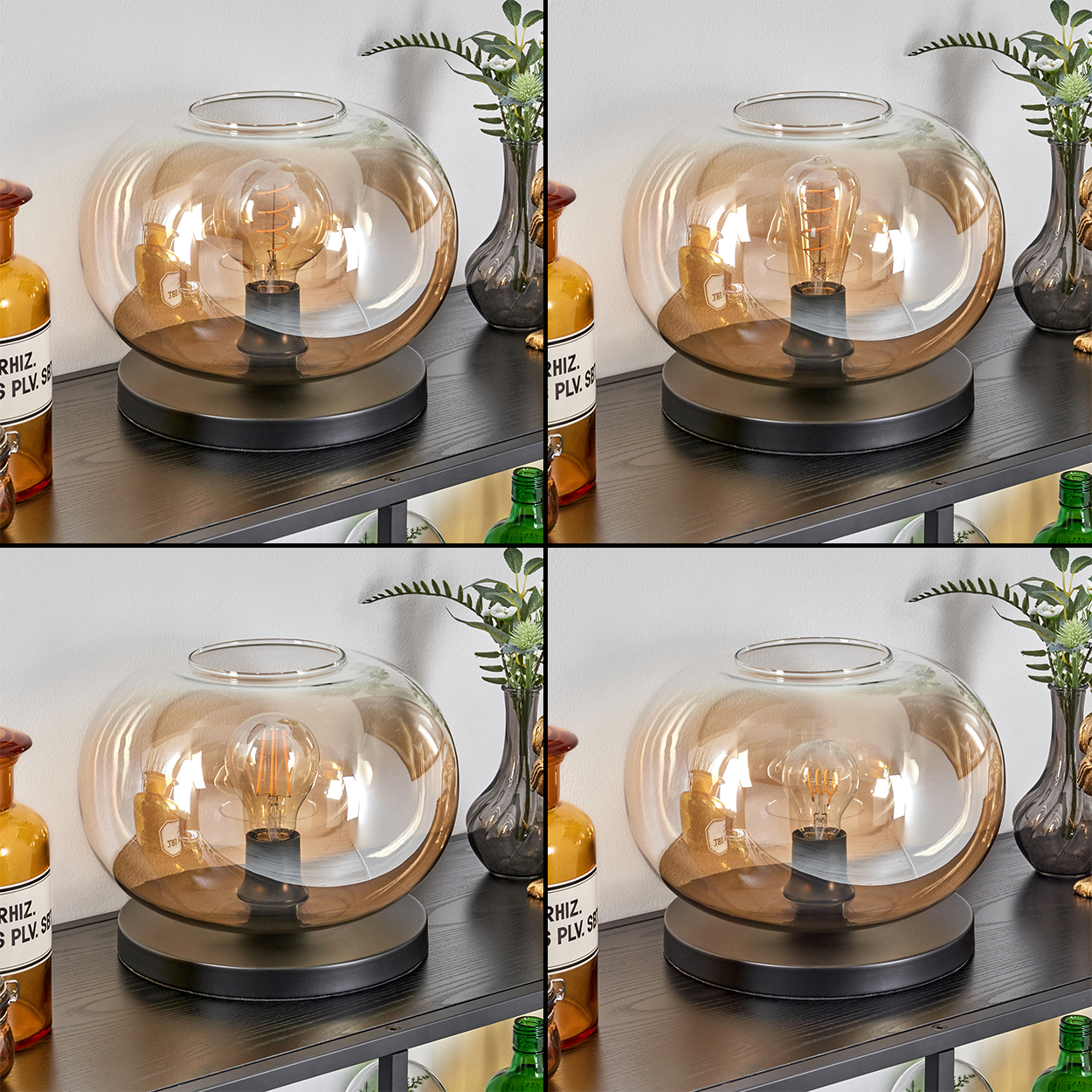 Eine dekorative Lampe mit einer Glühbirne steht auf einem schwarzen Regal. Daneben stehen Flaschen und Vasen mit Pflanzen.