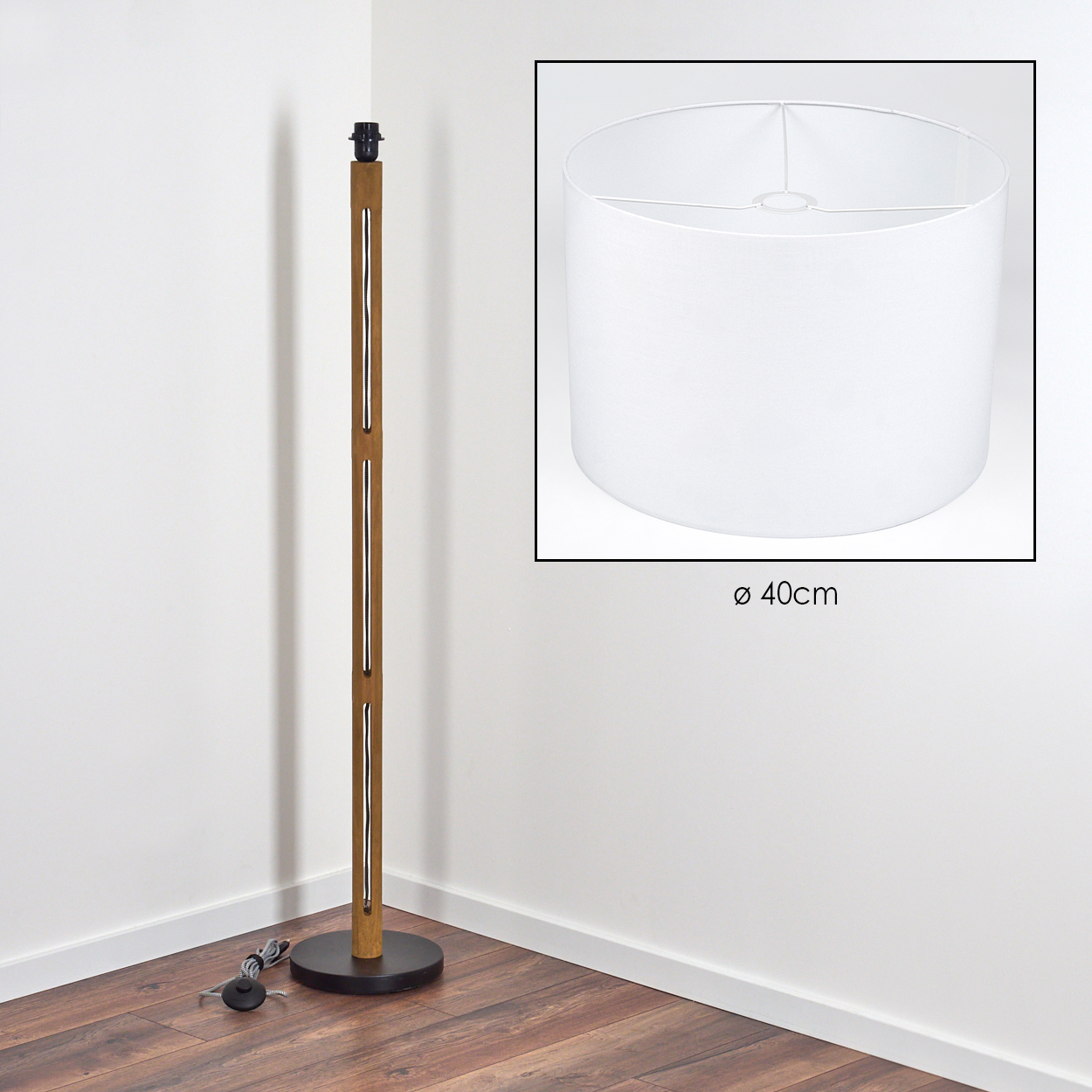 Eine Stehlampe aus Holz steht in einer Ecke mit weißem Lampenschirm. Der Schirm wird in einem Quadrat mit Durchmesser angezeigt.