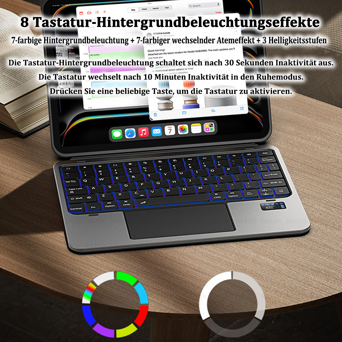 Ein Tablet mit Tastatur. Die Tastatur leuchtet in mehreren Farben. Auf einem Holztisch befinden sich auch Farbkreise.