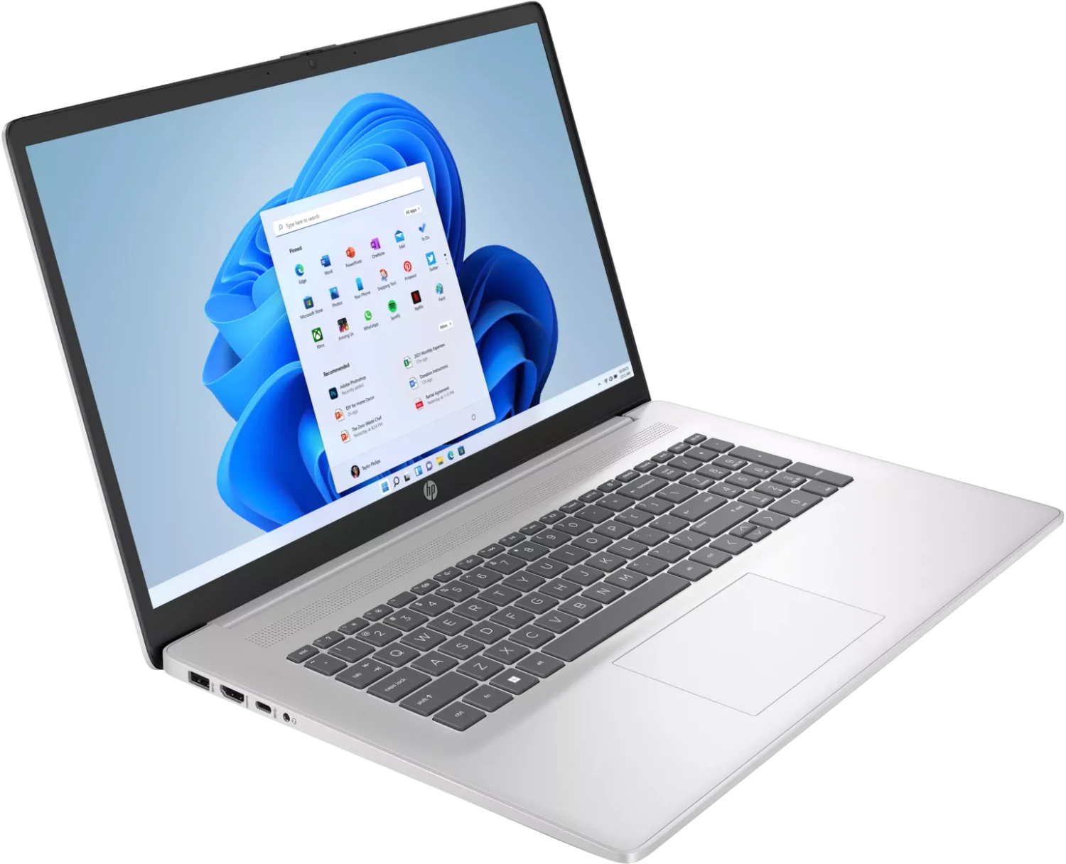 Silberner HP-Laptop, geöffnet, mit Windows 11-Oberfläche. Der Bildschirm zeigt App-Symbole und einen blauen abstrakten Hintergrund. Tastatur sichtbar.