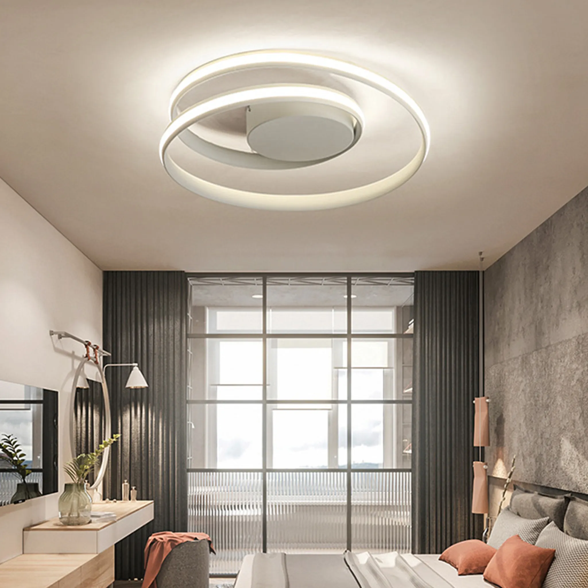 Ein modernes Schlafzimmer mit einer spiralförmigen Deckenleuchte. Es gibt einen Schminktisch, ein großes Fenster, ein Bett.