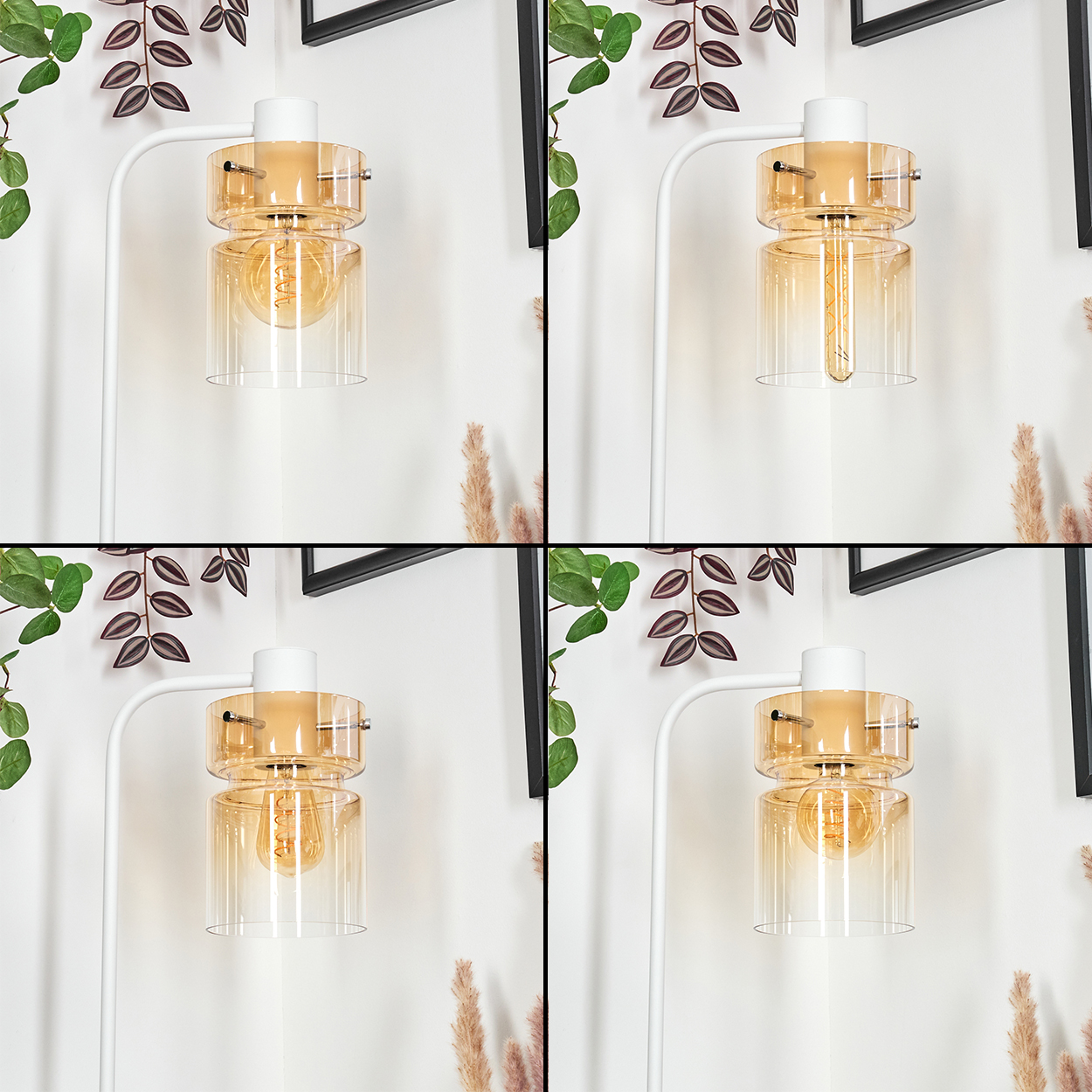 Eine moderne Lampe mit bernsteinfarbenen Glasschirmen und einer sichtbaren Glühbirne, vor einer weißen Wand mit Pflanzen und Rahmen.