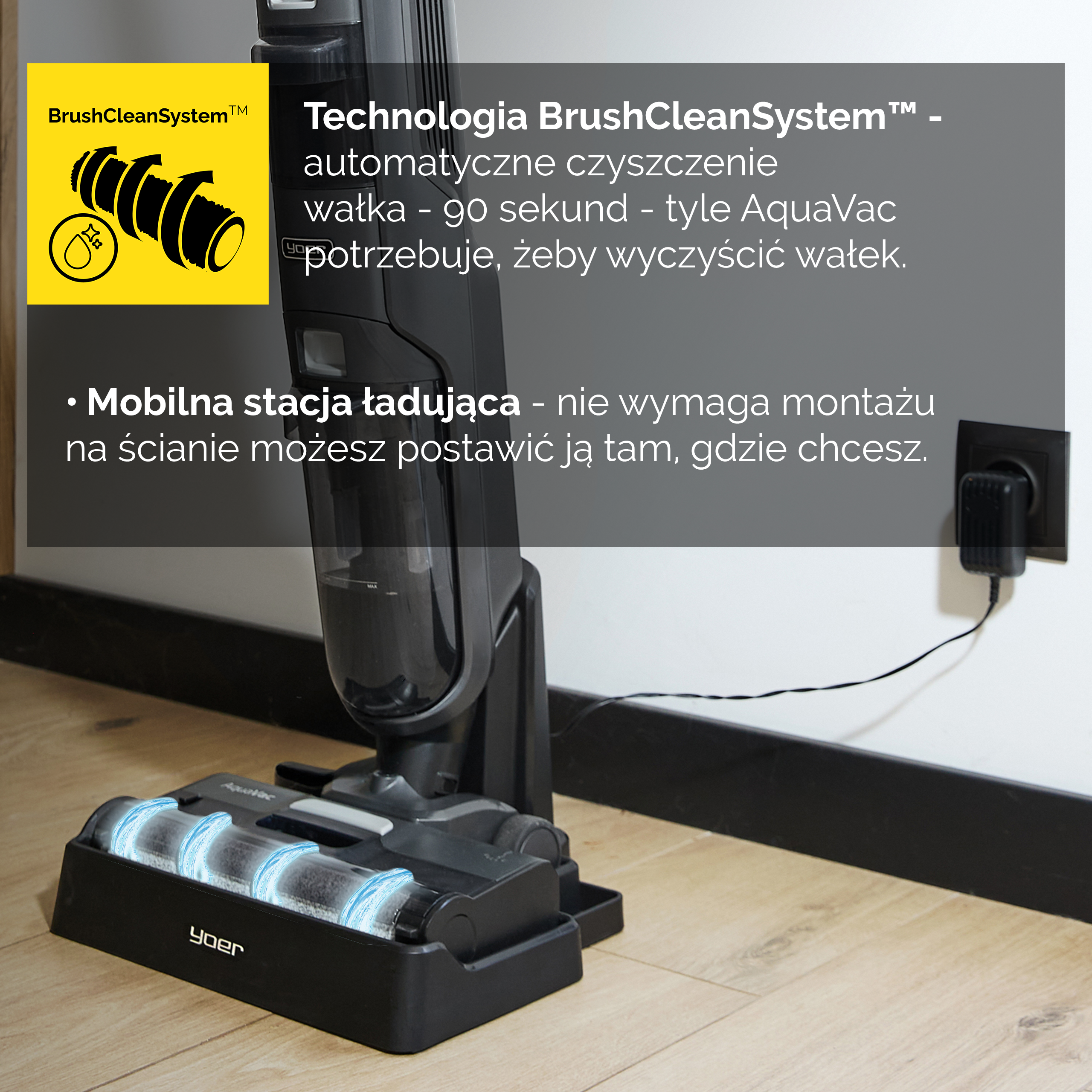 Czarny odkurzacz ze stacją ładującą stoi na drewnianej podłodze, z tekstem na ścianie.