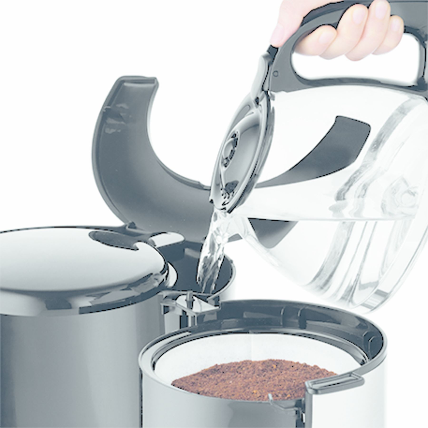 A hand pours water from a glass carafe into a coffee maker's filter basket filled with coffee grounds.