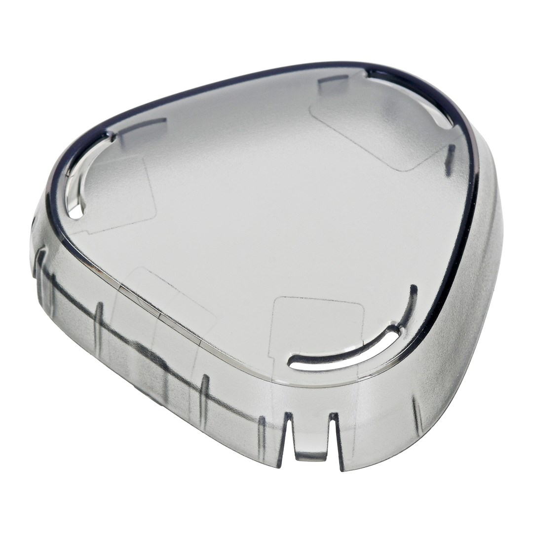 Przezroczysty, plastikowy obiekt w kształcie tarczy na białym tle. Ma ciemną obwódkę. Obiekt posiada szereg pionowych szczelin.