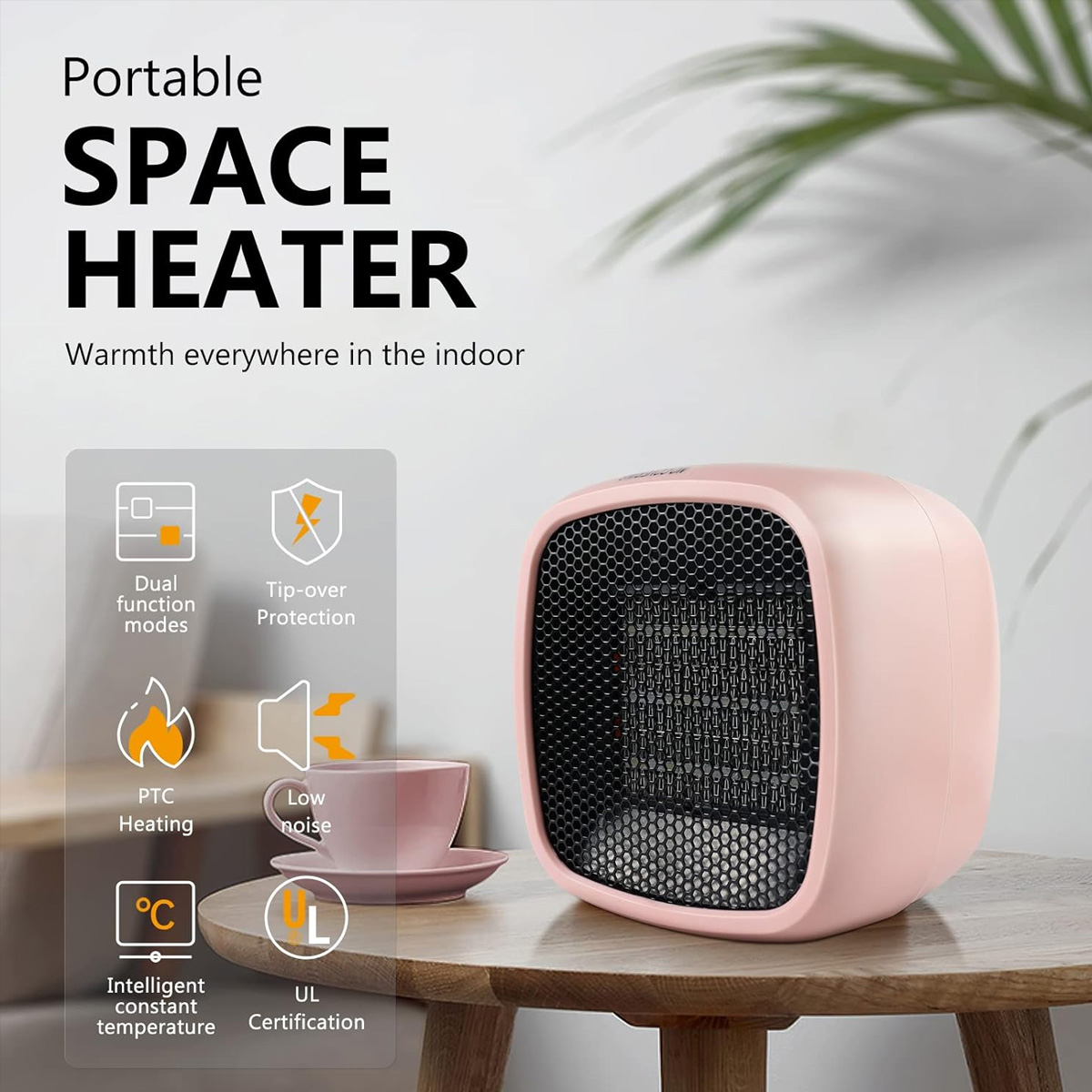 Ein rosa Raumheizer mit schwarzer Mesh-Front. Symbole zeigen Funktionen wie Dual-Modi, PTC-Heizung und Kippschutz. Eine Tasse ist in der Nähe.