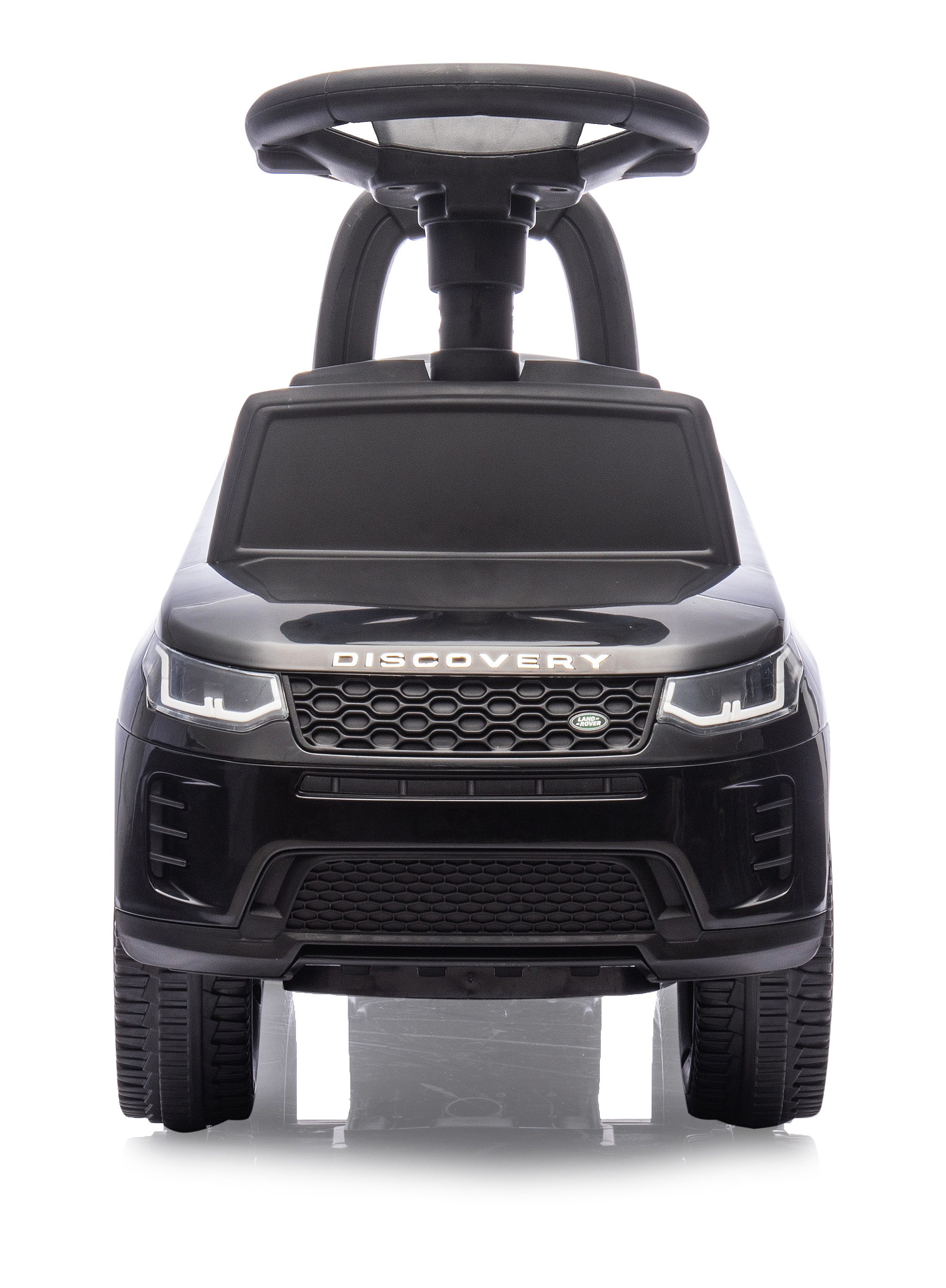 Un Land Rover Discovery giocattolo nero. Ha un volante, fari e un logo 'DISCOVERY'. Lo sfondo è bianco.