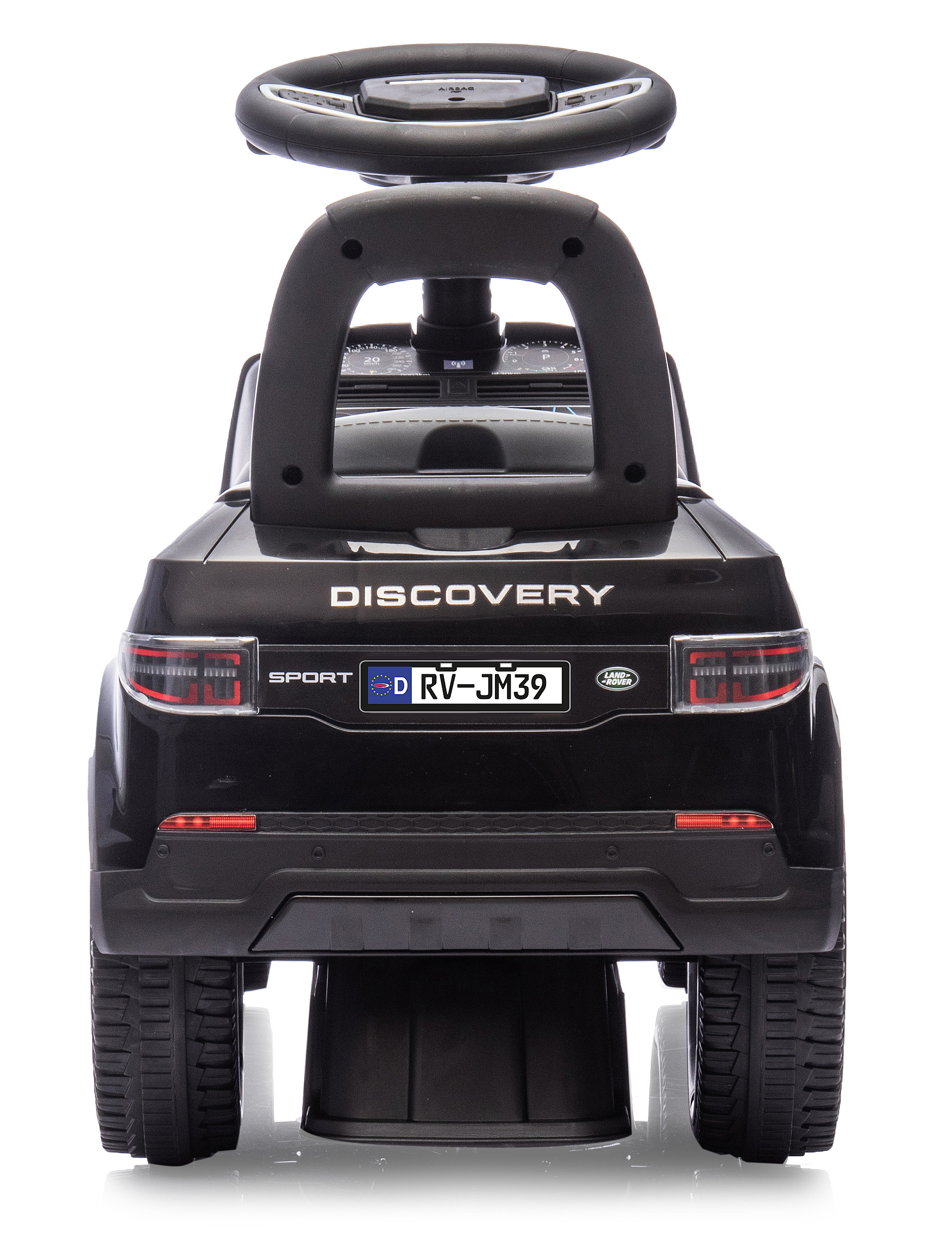 Un'auto giocattolo nera con 'DISCOVERY SPORT' sul retro. Ha un volante e una targa tedesca.