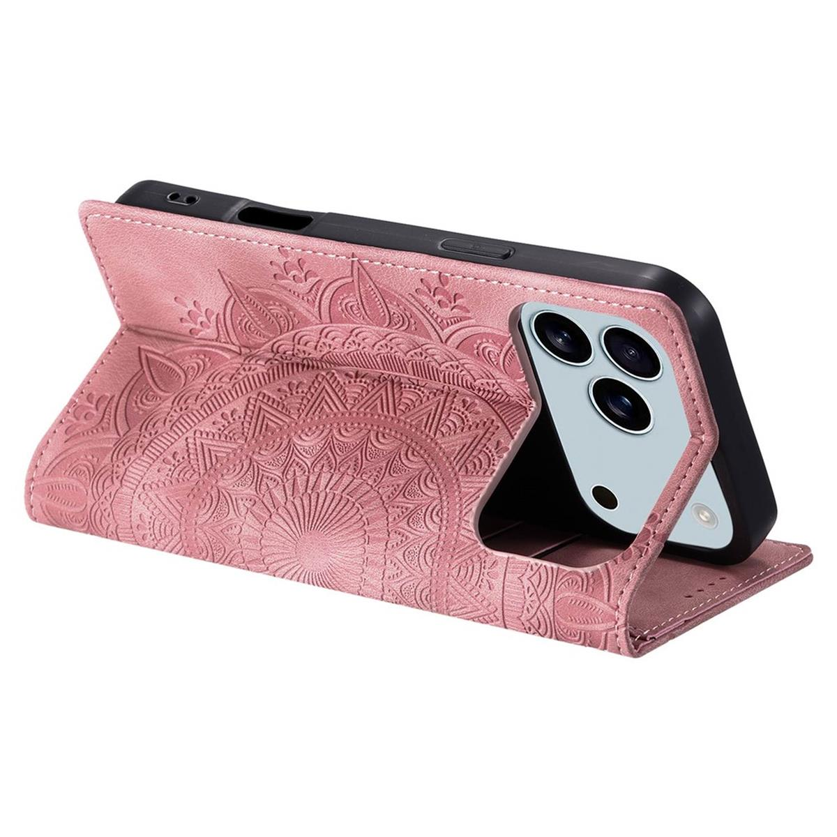 Eine rosa Handyhülle mit Mandala-Design hält ein schwarzes Telefon. Die Hülle ist geöffnet, Telefon ist aufgestellt.