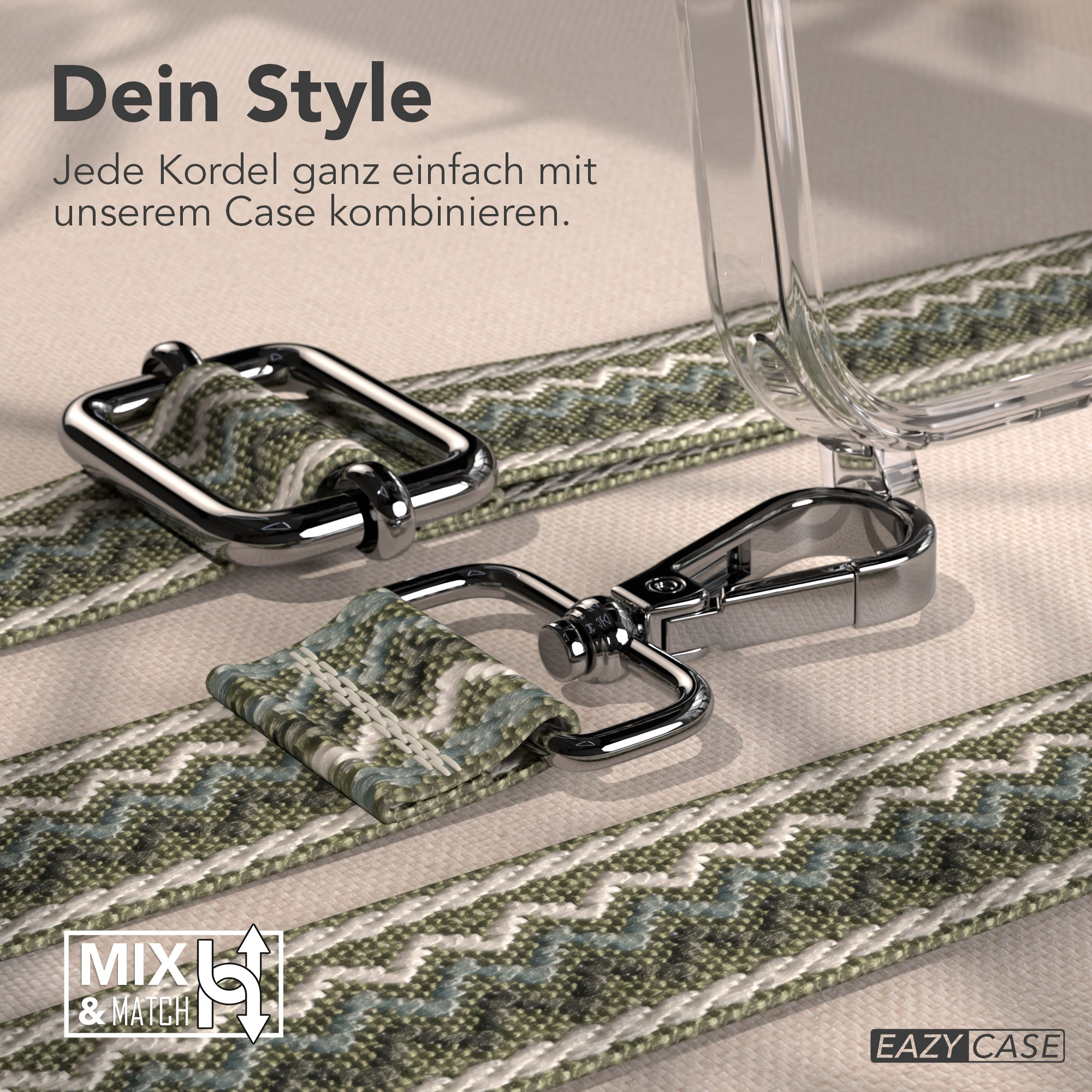Ein Handyhüllenriemen mit Metallverschlüssen, grün-weiß gewebtem Stoff und einer transparenten Handyhülle auf beigem Untergrund.