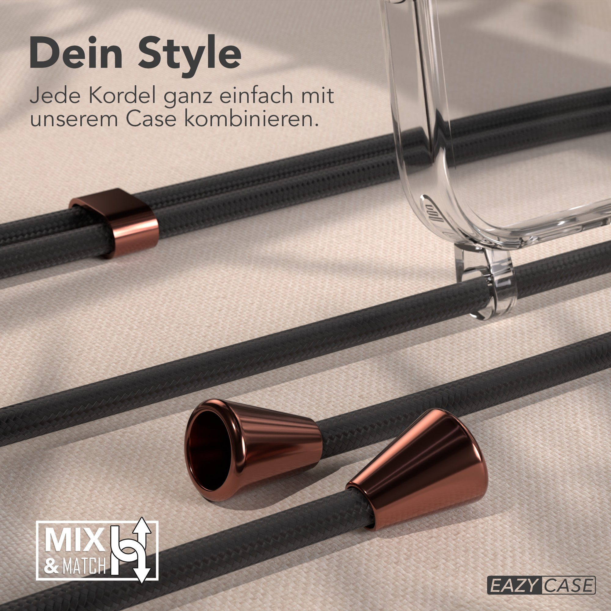 Das Bild zeigt schwarze Kordeln mit kupferfarbenen Akzenten und eine transparente Handyhülle. Der Text lautet 'Dein Style' und 'Mix & Match'.