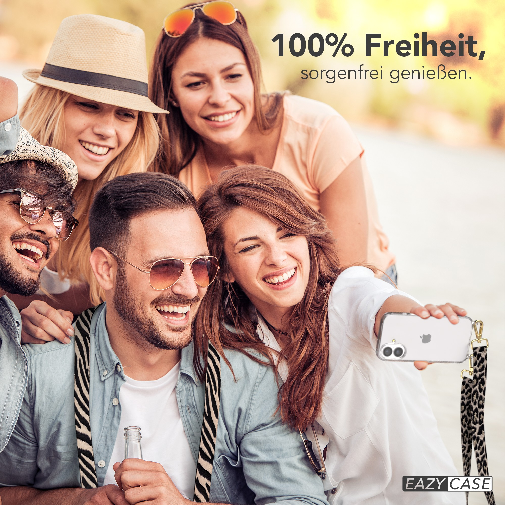Fünf lächelnde Personen machen ein Selfie. Einer hält das Telefon mit Leopardenriemen. Text: 100% Freiheit, unbeschwert genießen.