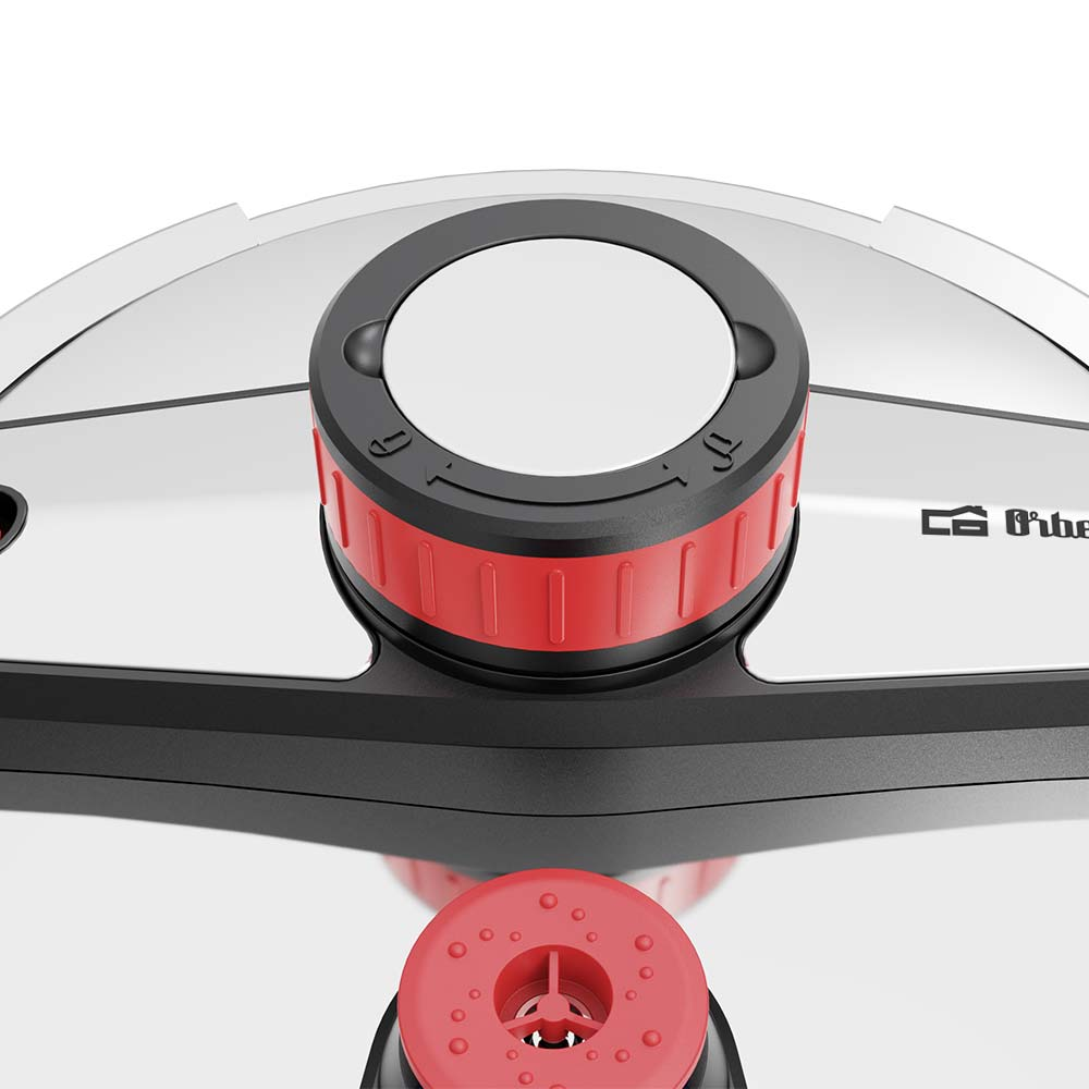 Primer plano de una tapa de olla a presión. Dial negro y rojo en la parte superior con círculo blanco. Superficie plateada.