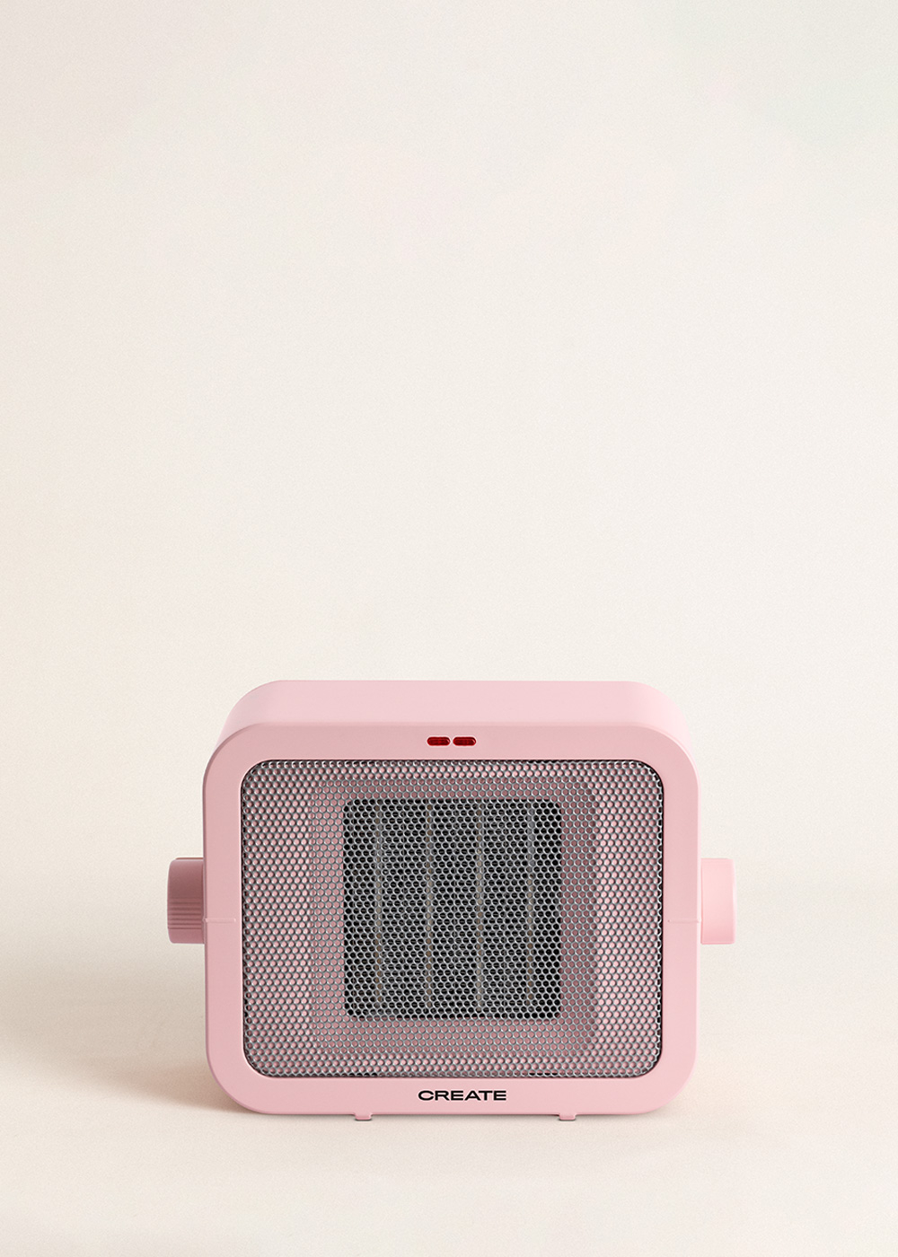 Un calefactor eléctrico rosa con rejilla frontal. Tiene un logo 'CREATE'. El fondo es beige claro.