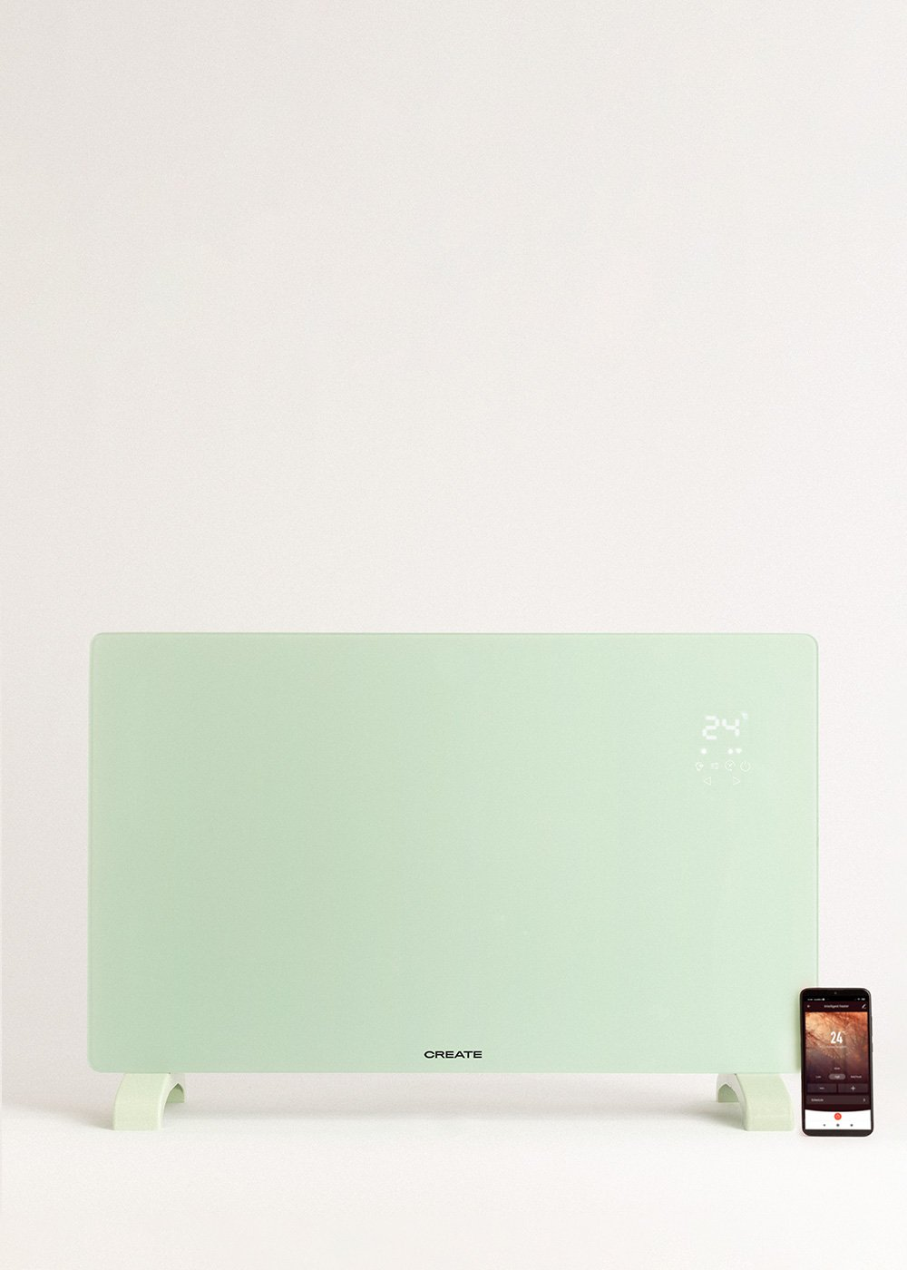 Un calefactor eléctrico verde menta con pantalla digital que muestra 24 grados y un teléfono inteligente que muestra la misma temperatura.