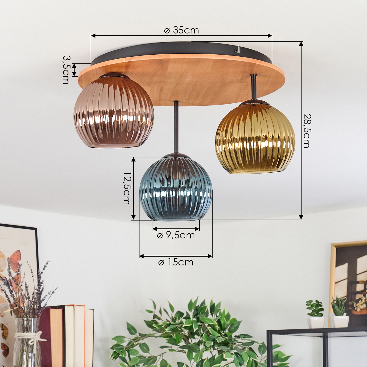 Eine Deckenleuchte mit drei Glaskugeln in Bronze, Blau und Gold hängt an einem Holzsockel. Abmessungen sind angegeben.