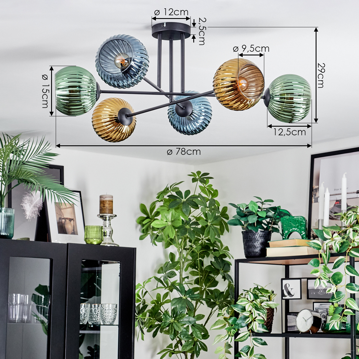 Eine moderne Deckenlampe mit Glaskugeln in Grün-, Bernstein- und Blautönen, die in einem Raum mit Pflanzen hängt.