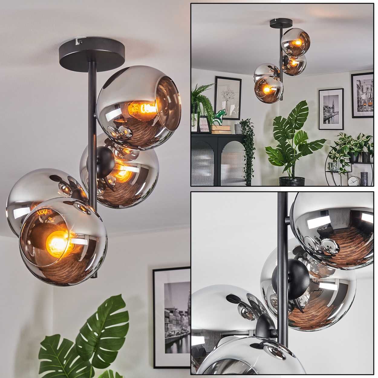 Eine moderne Deckenlampe mit vier Glaskugelschirmen. Die Schirme sind silberfarben, mit sichtbaren Glühbirnen im Inneren. Die Lampe ist an einer schwarzen Stange befestigt.