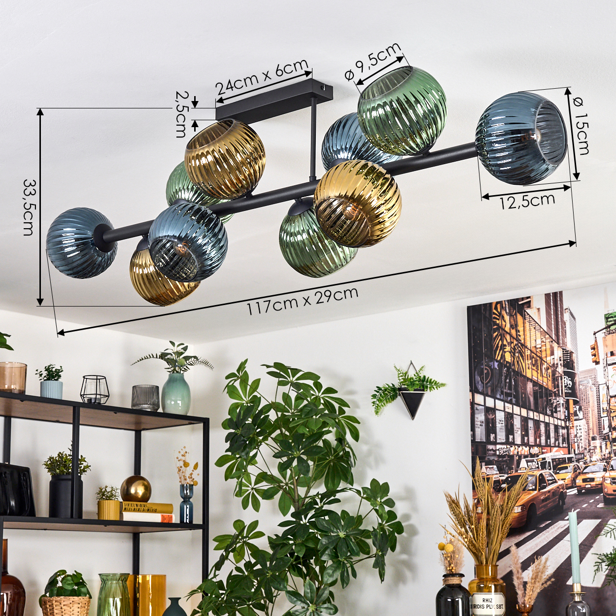 Eine moderne Deckenlampe mit farbigen Glaskugeln. Der Raum hat ein Regal mit Dekorationen und ein Stadtgemälde.