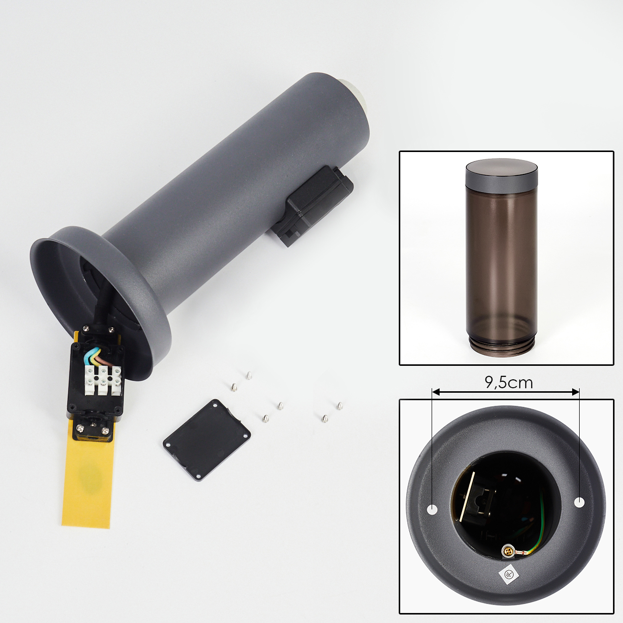 Zerlegte graue Lampe mit elektrischen Bauteilen, kleiner schwarzer Abdeckung, Schrauben und einem durchsichtigen Zylinder. Details des Sockels werden gezeigt.