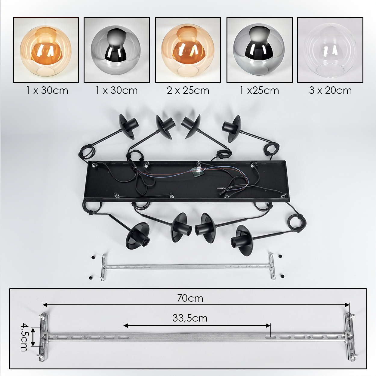 Draufsicht auf eine zerlegte Leuchte mit Glaskugeln, schwarzen Leuchtenteilen und einer Metallhalterung.